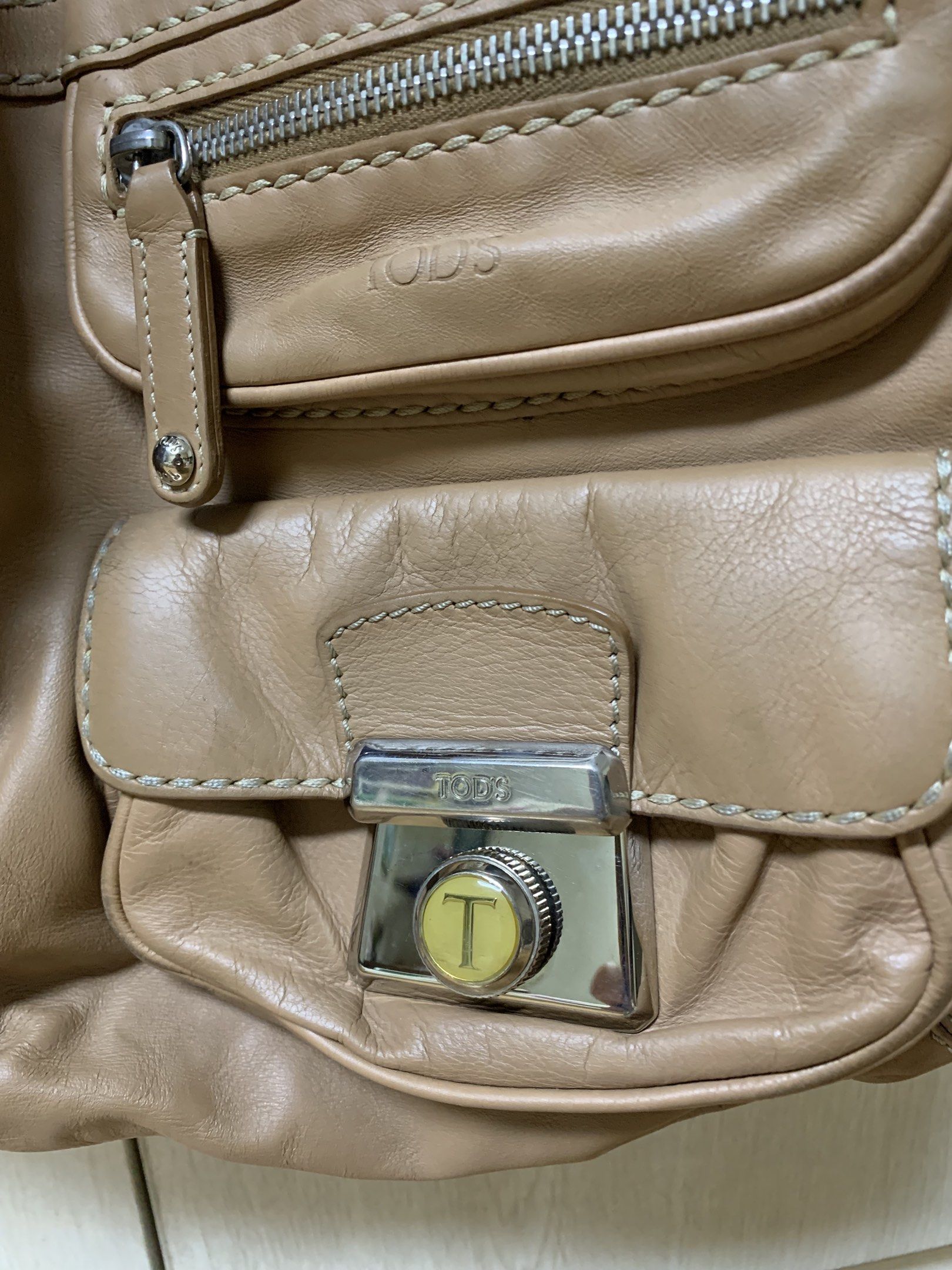 Authentic Tod's Leather Bag (Category: Luxury Bags & Wallets) located in San Juan City. Submitted by andyria (Listing ID 1417755921, Image 2). Description: - Tod's shoulder bag - Made of leather - Multiple exterior pockets - Secure zip closure - Versatile top handle and shoulder strap - Iconic Tod's metal clasp Flaw: last pic - faded patch at the back.