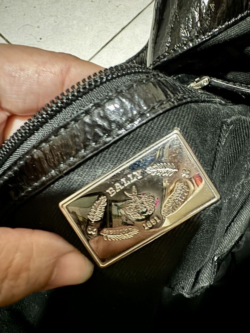 Bally Black Quilted Shoulder Bag (Category: Luxury Bags & Wallets) located in Pasig City. Submitted by Monica.RB (Listing ID 1417647181, Image 2). Description: - Bally black quilted shoulder bag - Glossy finish - Shoulder strap - Zipper closure - Bally logo plate inside - Textured design - Leather tag with brand name - Silver hardware -Limited edition -Only concern -- there's a part that is sticky but not affect the total condition and beauty of 