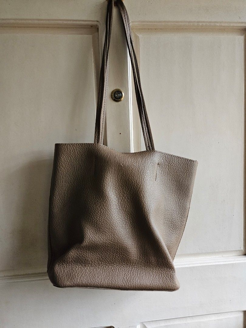 Brown Leather Tote Bag (Category: Tote Bags) located in Antipolo. Submitted by ibskikayshop (Listing ID 1417666290, Image 3). Description: - Brown leather tote bag - Long shoulder straps - Rectangular design - Textured leather material - Visible stitching details - Suitable for everyday use.