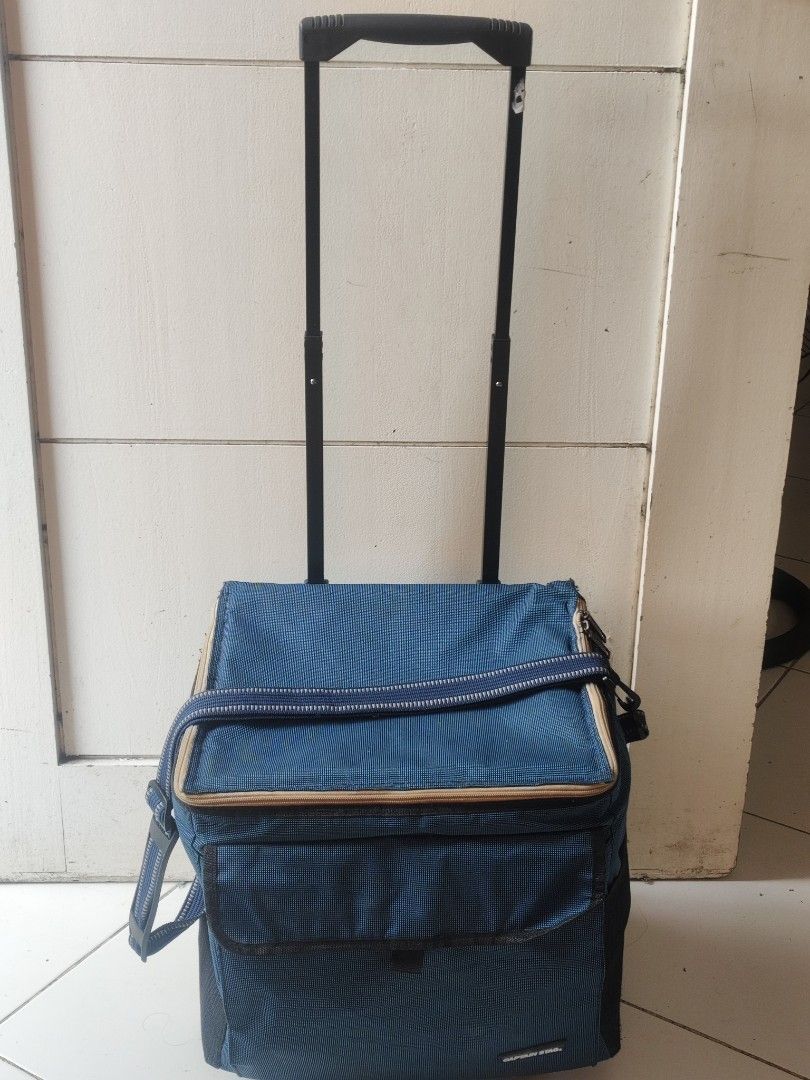 Captain Stag Rolling Cooler Bag (Category: Food Organization & Storage) located in Manila. Submitted by babz30261 (Listing ID 1417698434, Image 1). Description: - Captain Stag rolling cooler bag - Blue exterior - Top handle and shoulder strap - Zippered closure - Insulated interior - Includes binoculars.