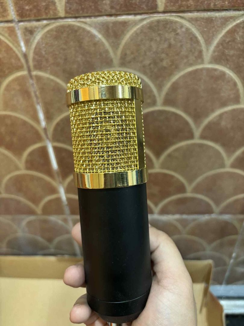 Condenser Microphone with Accessories (Category: Microphones) located in Manila. Submitted by jjalbert (Listing ID 1417613426, Image 3). Description: - Condenser microphone with stand, pop filter, and connecting cables included. - Stylish design: Gold mesh head and black body. - Comes in original packaging. - Ready to use for recording vocals or instruments..