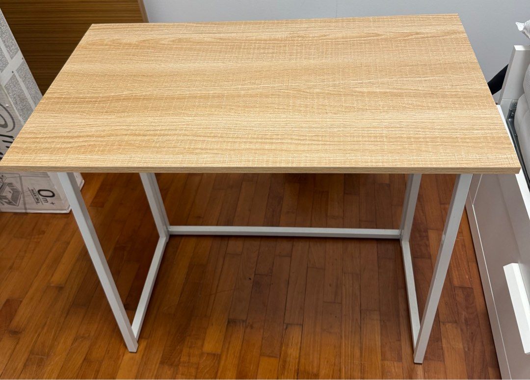Foldable table (Category: Tables & Sets) located in Singapore. Submitted by vigneshvenkatesh (Listing ID 1417786937, Image 3). Description: - Foldable study table - Sturdy white metal frame - Open size: 79cm x 45cm.