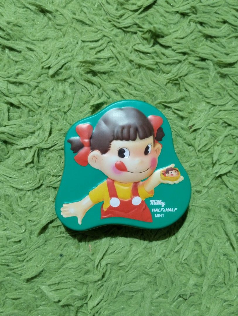 Fujiya Milky Half Half Mint Tin Box (Category: Storage Boxes & Baskets) located in Davao. Submitted by mengsmixitems (Listing ID 1417621775, Image 1). Description: - Collectible Fujiya Milky Half Half Mint tin box - Features a cute cartoon character - Unique shape and mint green color - Silver and blue interior - Japanese text and barcode on the back.