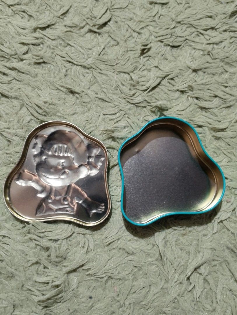 Fujiya Milky Half Half Mint Tin Box (Category: Storage Boxes & Baskets) located in Davao. Submitted by mengsmixitems (Listing ID 1417621775, Image 2). Description: - Collectible Fujiya Milky Half Half Mint tin box - Features a cute cartoon character - Unique shape and mint green color - Silver and blue interior - Japanese text and barcode on the back.