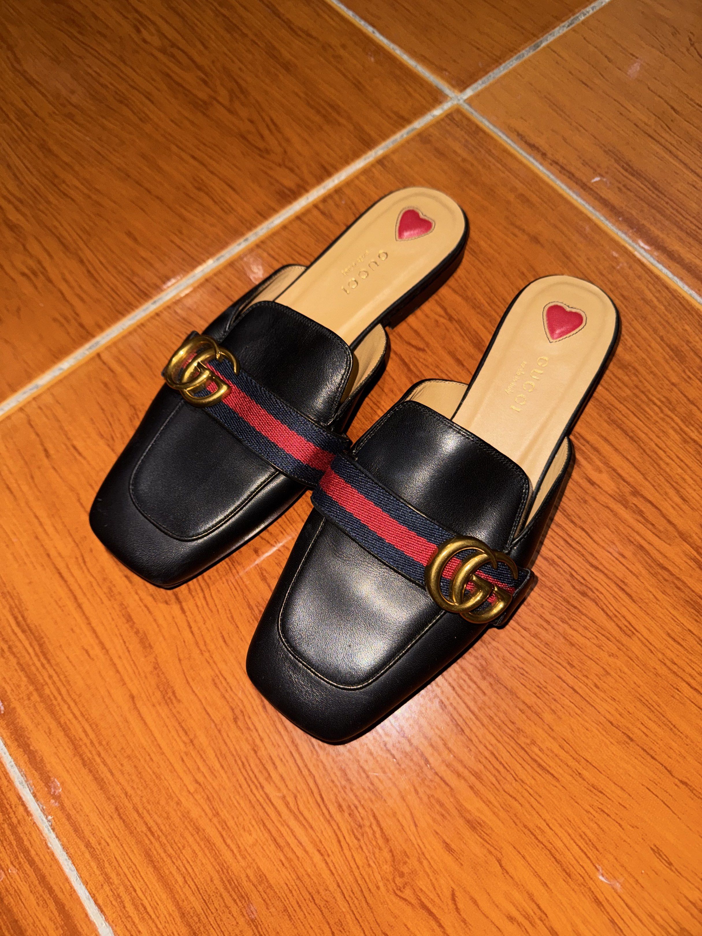 Gucci Peyton Mules (Category: Flats & Sandals) located in Quezon City. Submitted by vodega (Listing ID 1417776469, Image 1). Description: - Authentic Gucci Peyton Mules - Color: Black - Size: 37 - Iconic GG hardware - Red and navy stripe detail - Heart design on insole - Made in Italy - Minor wear on soles.
