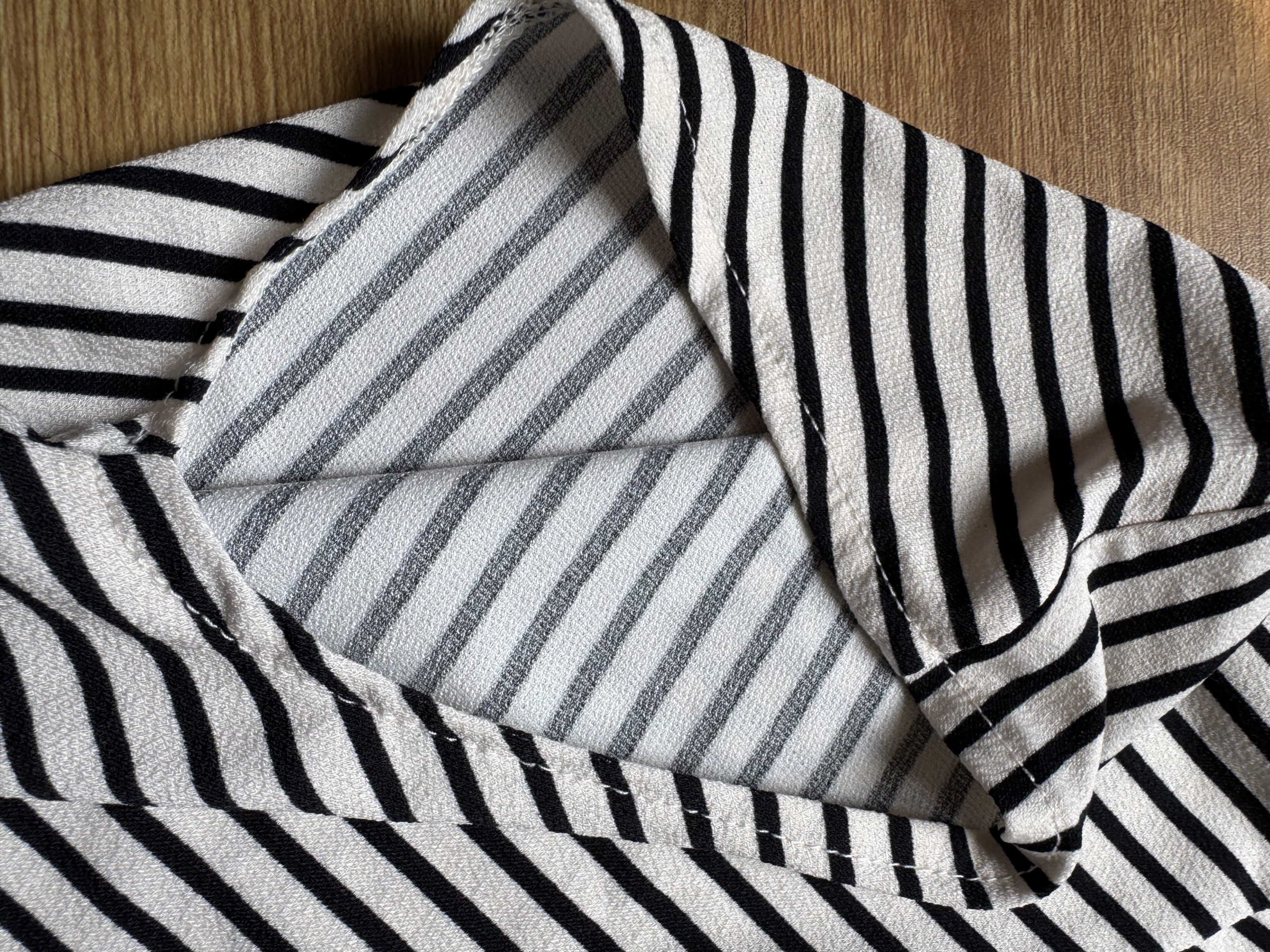 H&M Striped Top - XS (Category: Blouses) located in Manila. Submitted by obach (Listing ID 1417736308, Image 3). Description: - H&M top - Black and white stripes - Unique neckline - XS size - Comfortable fit - Perfect for casual wear - Versatile wardrobe addition.