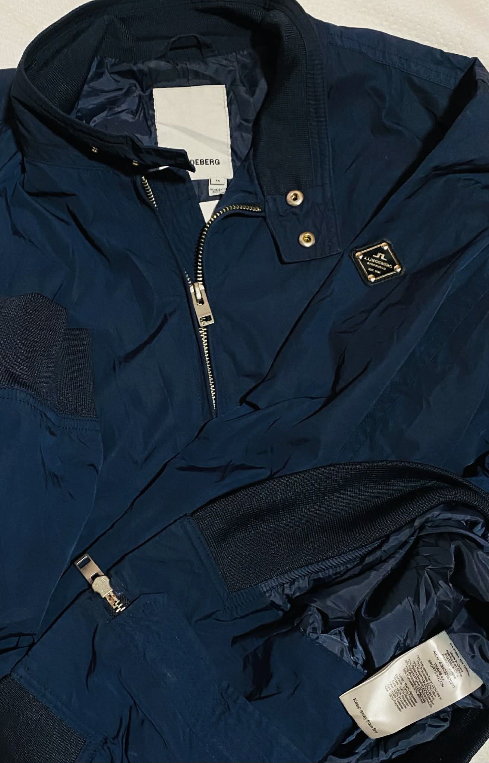 J. Lindeberg Travis 42 Sports Nylon Jacket (Category: Coats, Jackets and Outerwear) located in Digos. Submitted by thrifthed.ph (Listing ID 1417639177, Image 1). Description: - Navy blue J. Lindeberg jacket - Model: Travis 42 Sports Nylon -Brandnew condi -with hangtag -Med fit large -dimes:21.5/28 -no issue -solid condi -solid colorate -cl:10/10 -complete tags -authentic -suitable for picky buyer - no return no exchange - Zip-up front - Ribbed cu