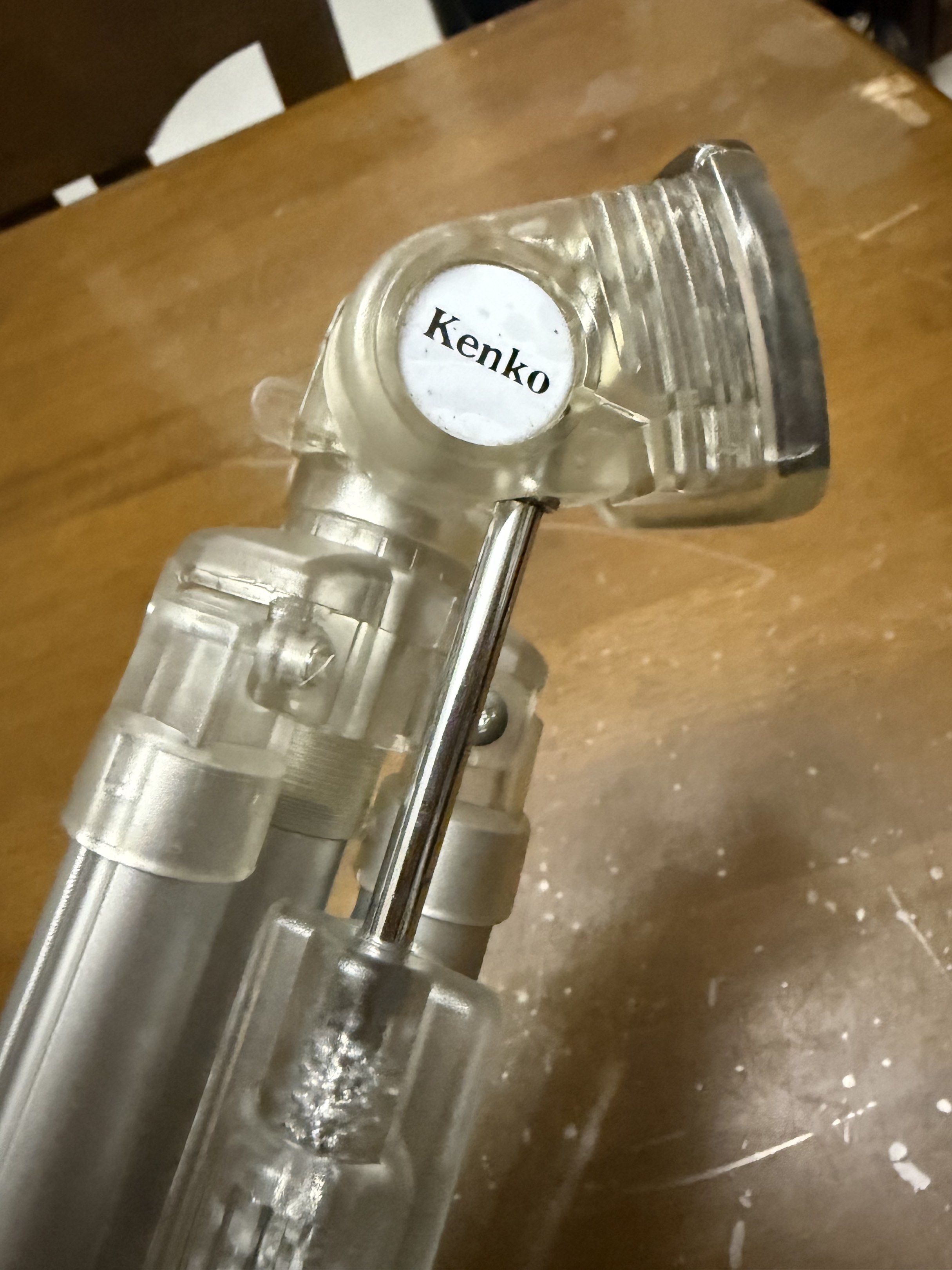Kenko SK-100 Tripod (Category: Tripods & Monopods) located in Pilar. Submitted by faveanyshop (Listing ID 1417654665, Image 3). Description: Kenko SK-100 tripod. It has a silver and clear plastic design. The tripod legs are adjustable and have clear plastic locking mechanisms. The head has a mounting plate for a camera. It is lightweight and portable, suitable for various photography needs. The tripod can be extended to a considerable height..