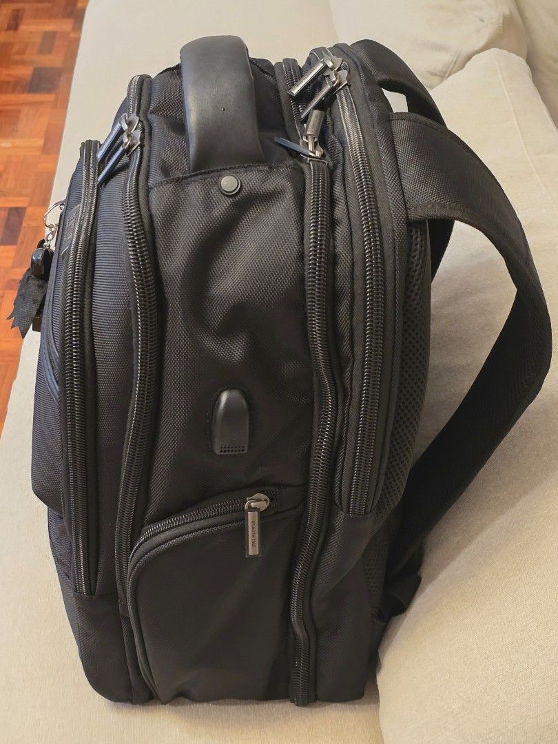 Kenneth Cole Reaction Black Backpack (Category: Backpacks) located in Makati City. Submitted by nelsonl4 (Listing ID 1417690318, Image 3). Description: - Kenneth Cole Reaction backpack - Black, textured fabric. blue inside - Multiple compartments and pockets - Dedicated laptop compartment - Zippered sections for organization - Padded handle and adjustable straps - ordered - Silver-toned hardware.