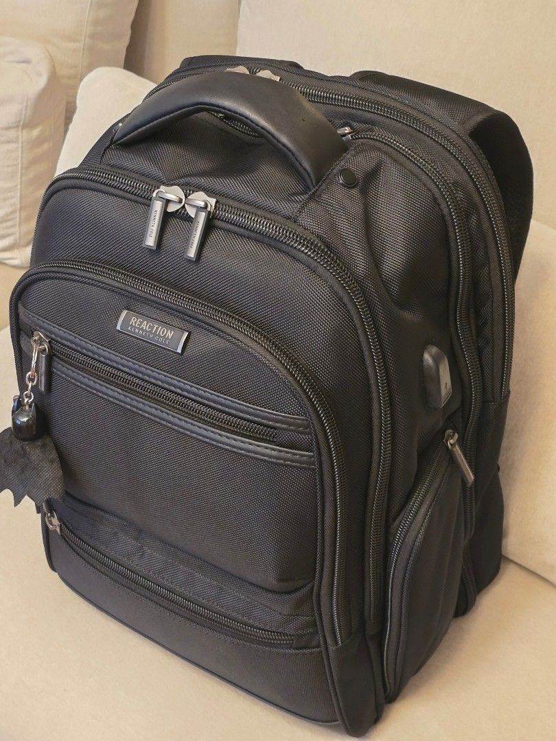 Kenneth Cole Reaction Black Backpack (Category: Backpacks) located in Makati City. Submitted by nelsonl4 (Listing ID 1417690318, Image 1). Description: - Kenneth Cole Reaction backpack - Black, textured fabric. blue inside - Multiple compartments and pockets - Dedicated laptop compartment - Zippered sections for organization - Padded handle and adjustable straps - ordered - Silver-toned hardware.