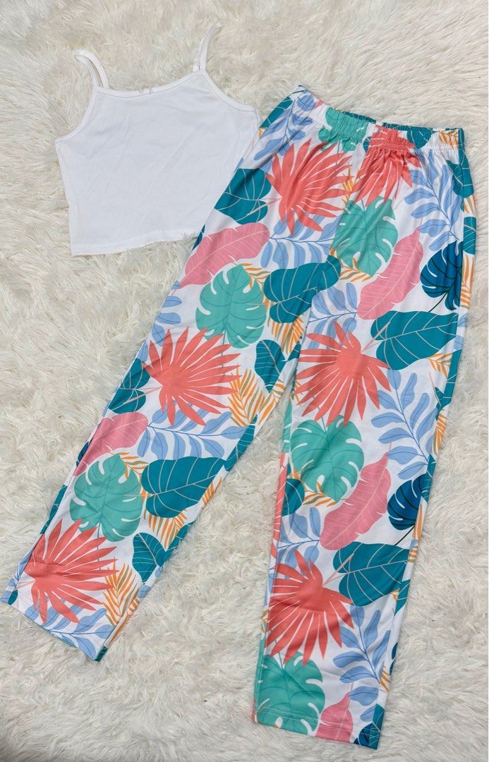 Kids' Tropical Print Outfit (Category: Babies & Kids Fashion) located in Cabuyao City. Submitted by affordable_love_items (Listing ID 1417805516, Image 1). Description: - Includes a white camisole top. - Features tropical print pants with green, pink, and orange leaves on a white background. - Size: 130..