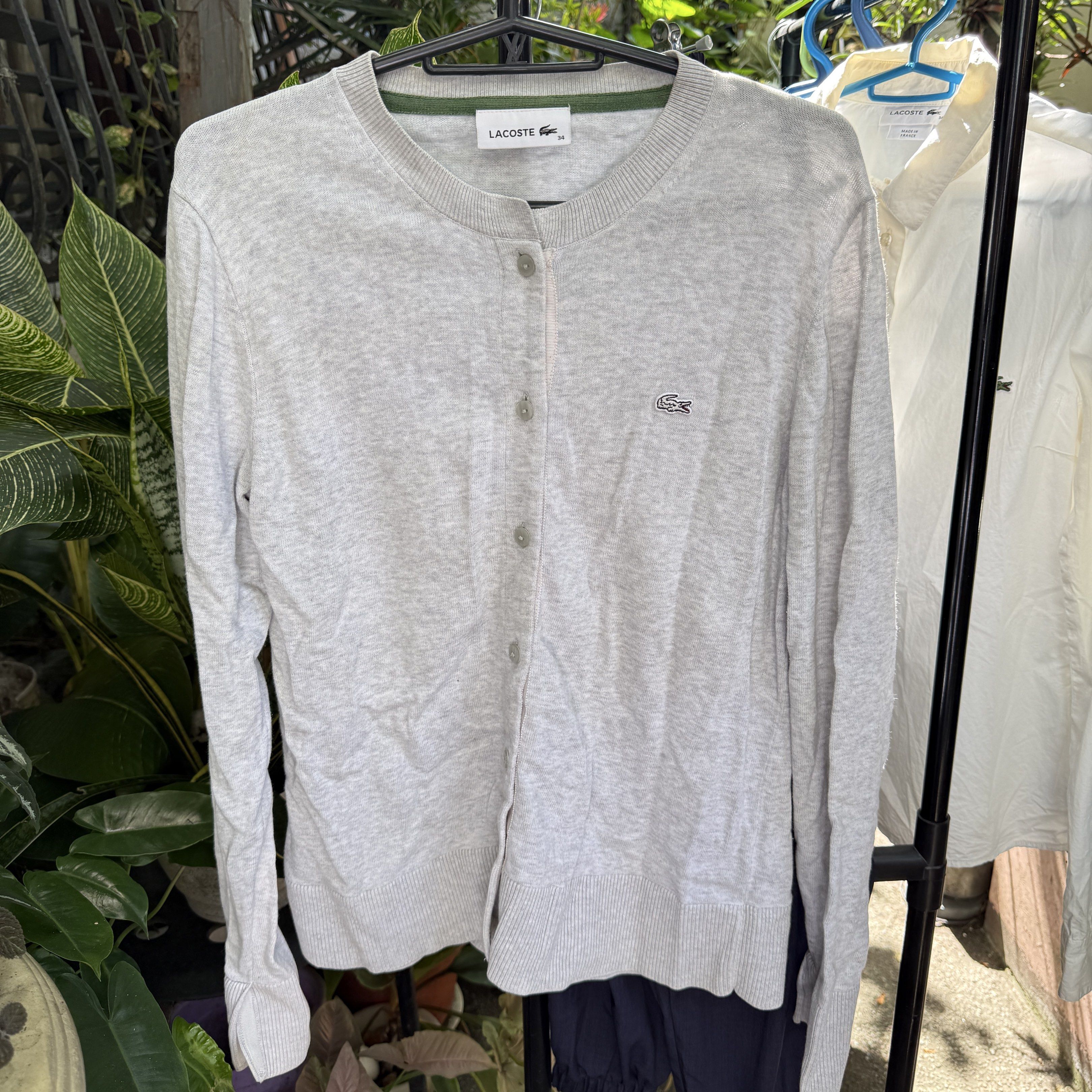 Lacoste Gray Grey Cardigan XS (Category: Coats, Jackets and Outerwear) located in Quezon City. Submitted by yth.ph (Listing ID 1417629035, Image 1). Description: - Light grey Lacoste cardigan - Crew neck - Button-down closure - Lacoste logo on chest - Size: 34 - Long sleeves - Ribbed hem and cuffs - Green collar trim.