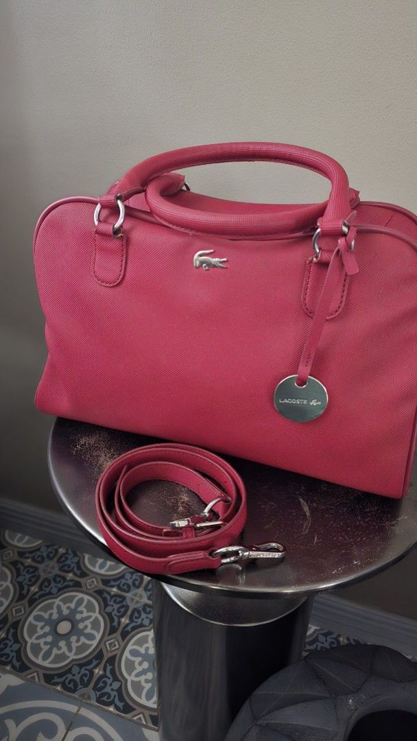Lacoste Red Handbag with Crossbody Strap (Category: Shoulder Bags) located in Quezon City. Submitted by mjkar (Listing ID 1417753560, Image 1). Description: - Authentic Lacoste handbag - red color - with detachable crossbodody strap - Silver-tone logo and hardware - Matching red interior lining - complete with original dust bag.