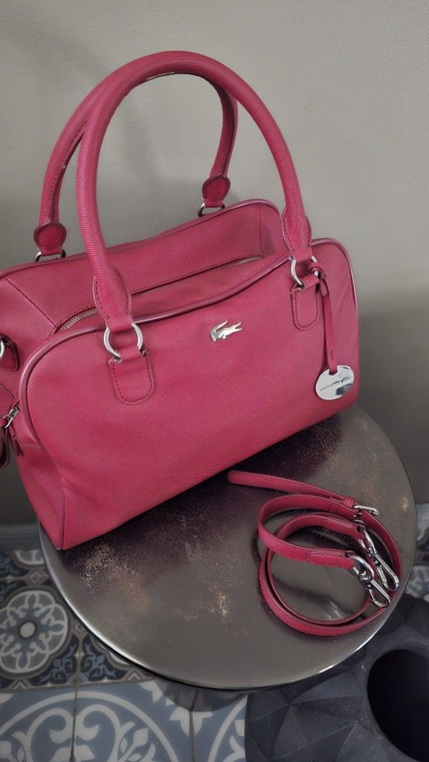 Lacoste Red Handbag with Crossbody Strap (Category: Shoulder Bags) located in Quezon City. Submitted by mjkar (Listing ID 1417753560, Image 2). Description: - Authentic Lacoste handbag - red color - with detachable crossbodody strap - Silver-tone logo and hardware - Matching red interior lining - complete with original dust bag.