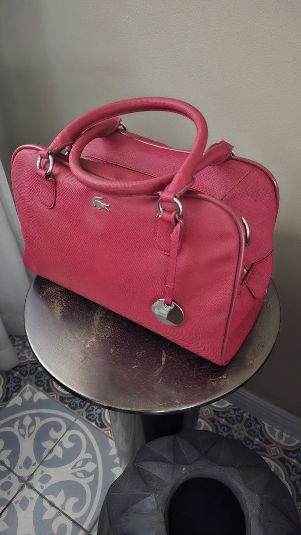 Lacoste Red Handbag with Crossbody Strap (Category: Shoulder Bags) located in Quezon City. Submitted by mjkar (Listing ID 1417753560, Image 3). Description: - Authentic Lacoste handbag - red color - with detachable crossbodody strap - Silver-tone logo and hardware - Matching red interior lining - complete with original dust bag.