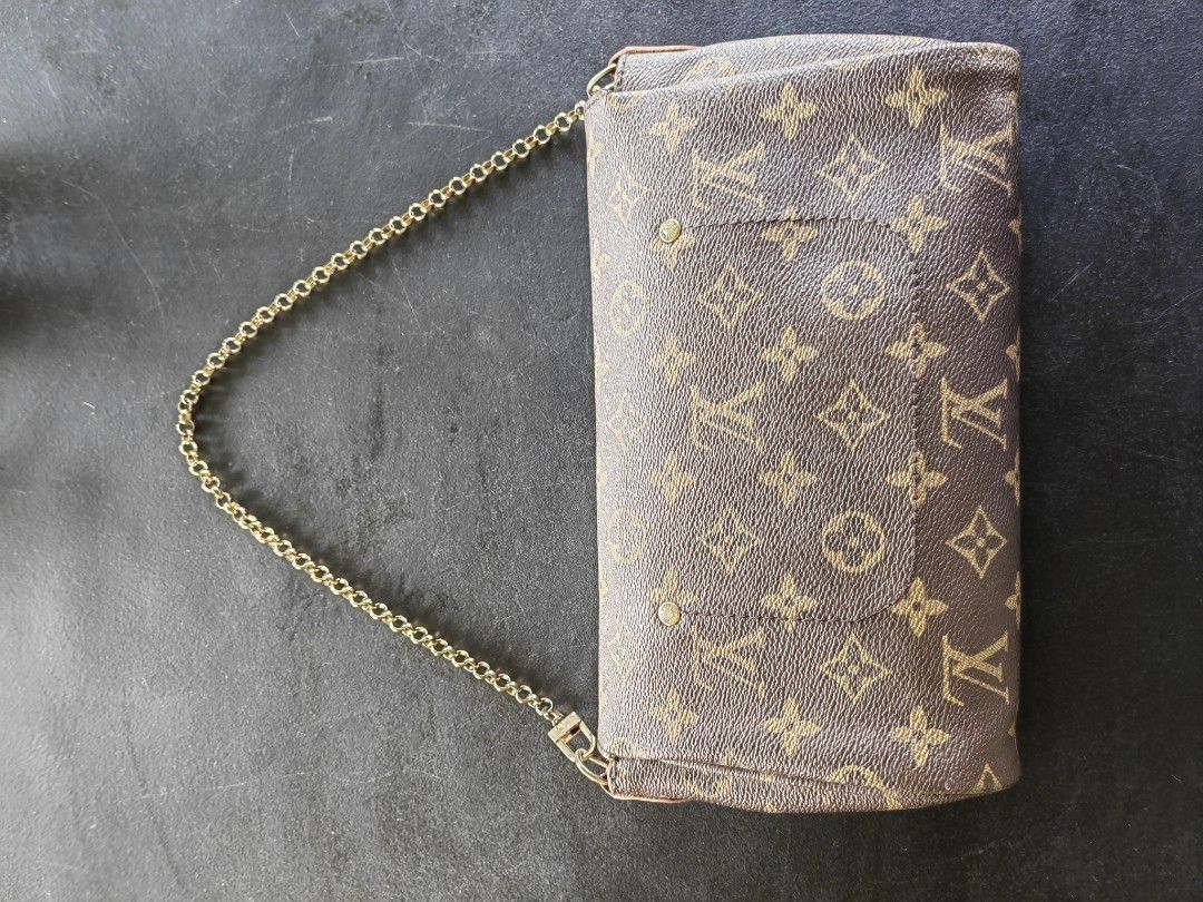 Louis Vuitton Monogram Clutch with Chain (Category: Luxury Bags & Wallets) located in Iloilo. Submitted by onyxpreloved.stuffs (Listing ID 1417614248, Image 3). Description: - Louis Vuitton Monogram clutch bag - Gold-tone chain strap - Flap closure with gold-tone metal bar - Purple interior lining - Includes serial number - Classic LV monogram pattern - Detachable strap strap 1900 each 2 for 3800 both coded..