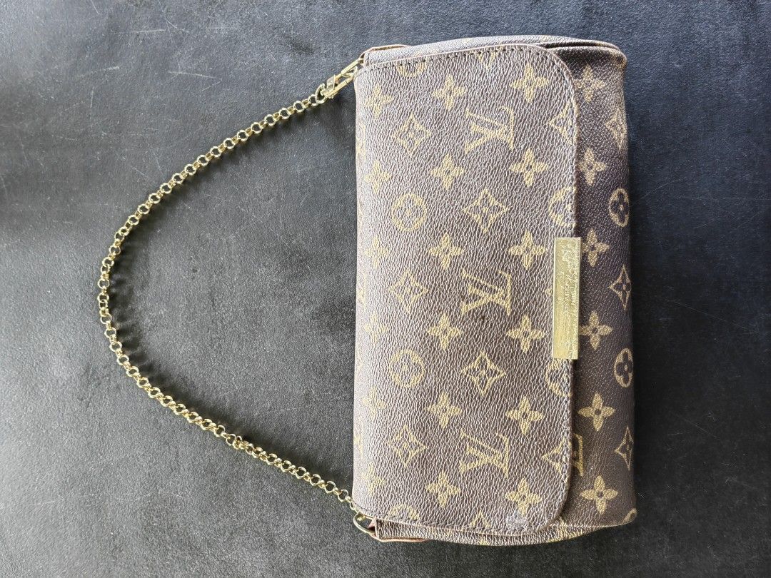 Louis Vuitton Monogram Clutch with Chain (Category: Luxury Bags & Wallets) located in Iloilo. Submitted by onyxpreloved.stuffs (Listing ID 1417614248, Image 2). Description: - Louis Vuitton Monogram clutch bag - Gold-tone chain strap - Flap closure with gold-tone metal bar - Purple interior lining - Includes serial number - Classic LV monogram pattern - Detachable strap strap 1900 each 2 for 3800 both coded..