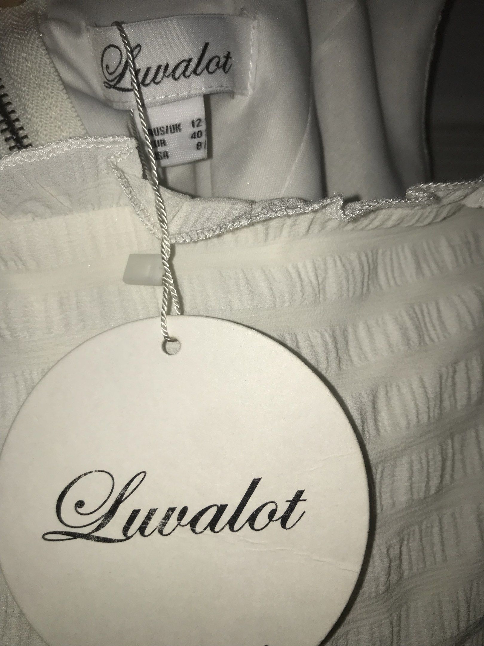Luvalot White Ruffle Crop Top (Category: Others Tops) located in Makati City. Submitted by closet.declutterph (Listing ID 1417783254, Image 2). Description: - Luvalot white crop top - Ruffle details - Square neckline - Ruffle straps - Textured fabric - Size: UK 12, EUR 40, US 8 - New with tags.