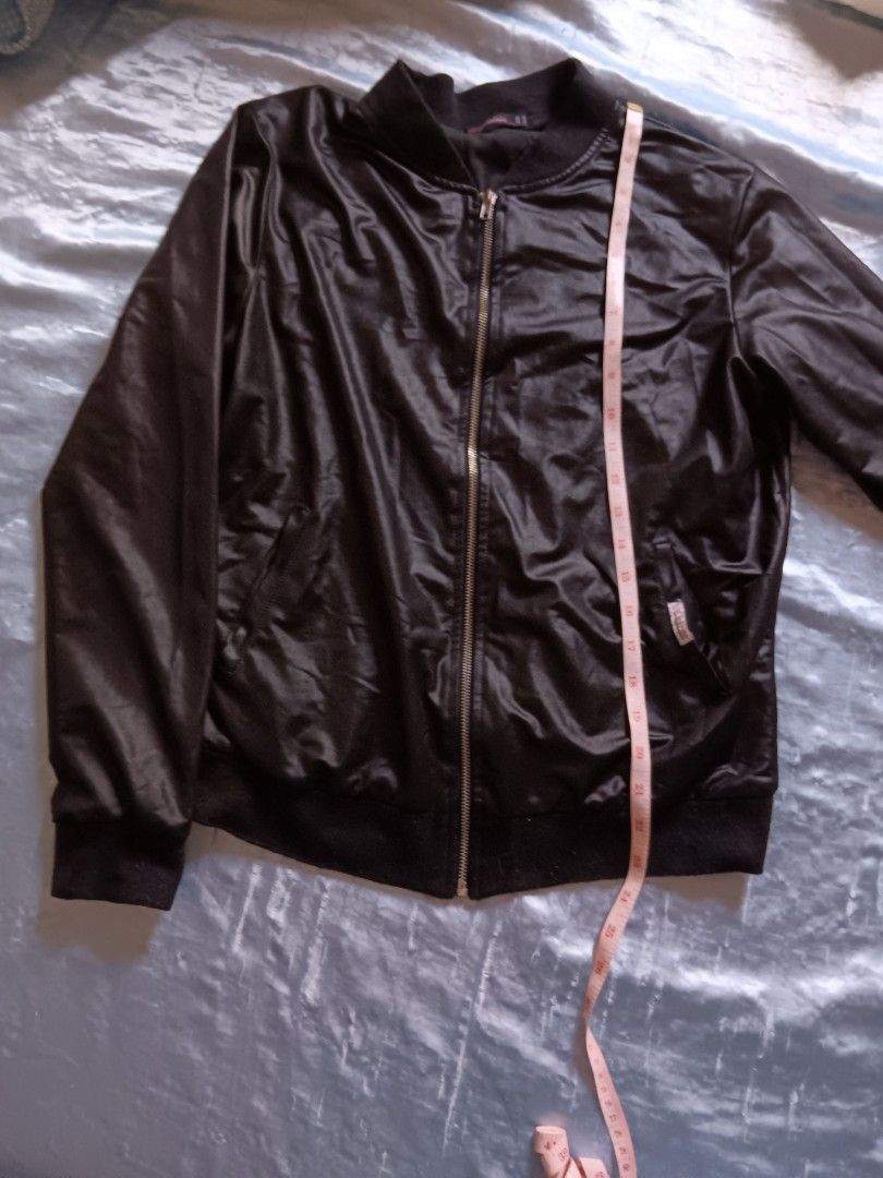 Material Girl Black Jacket (Category: Coats, Jackets and Outerwear) located in Manila. Submitted by declutteraf (Listing ID 1417649373, Image 1). Description: - Material Girl black jacket - Zipper closure - Ribbed collar and cuffs - Shiny material - Front pocket - Chest measurement: approximately 17 inches.