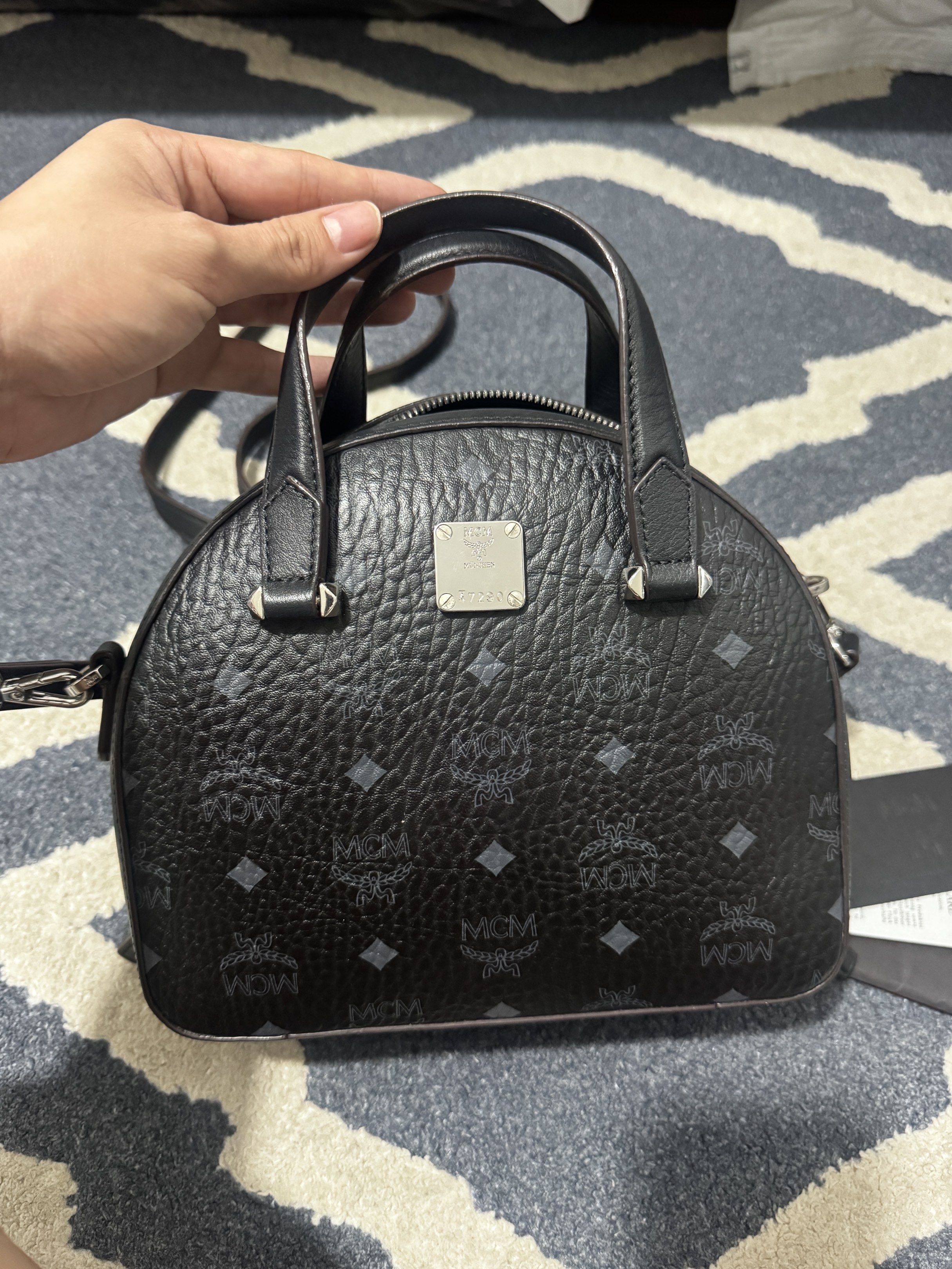MCM Mini Boston Bag Black (Category: Luxury Bags & Wallets) located in Manila. Submitted by tin_preloved_028 (Listing ID 1417752762, Image 3). Description: - Authentic MCM mini Boston bag - Black color - Iconic MCM logo pattern - Top handle and Body Bag - Detachable shoulder strap - Includes original cards - Secure zip closure - Stylish and compact - with Dust Bag .