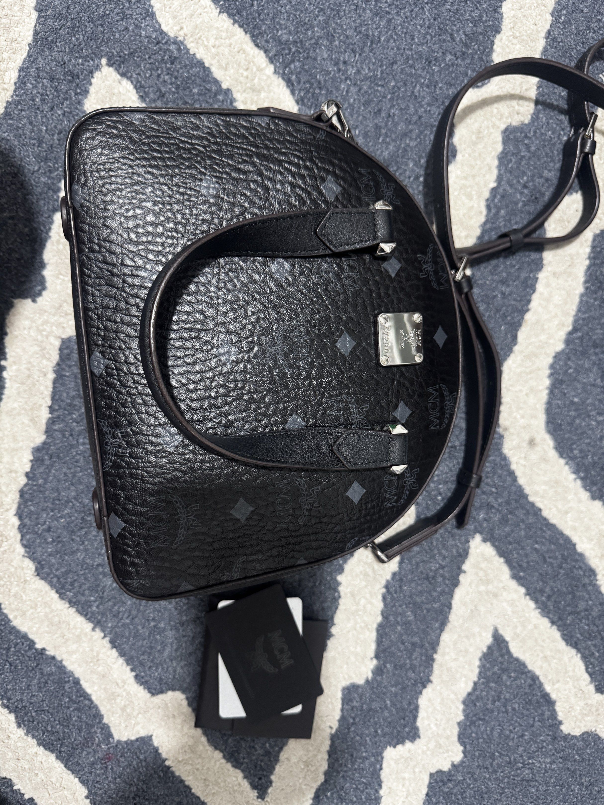 MCM Mini Boston Bag Black (Category: Luxury Bags & Wallets) located in Manila. Submitted by tin_preloved_028 (Listing ID 1417752762, Image 2). Description: - Authentic MCM mini Boston bag - Black color - Iconic MCM logo pattern - Top handle and Body Bag - Detachable shoulder strap - Includes original cards - Secure zip closure - Stylish and compact - with Dust Bag .