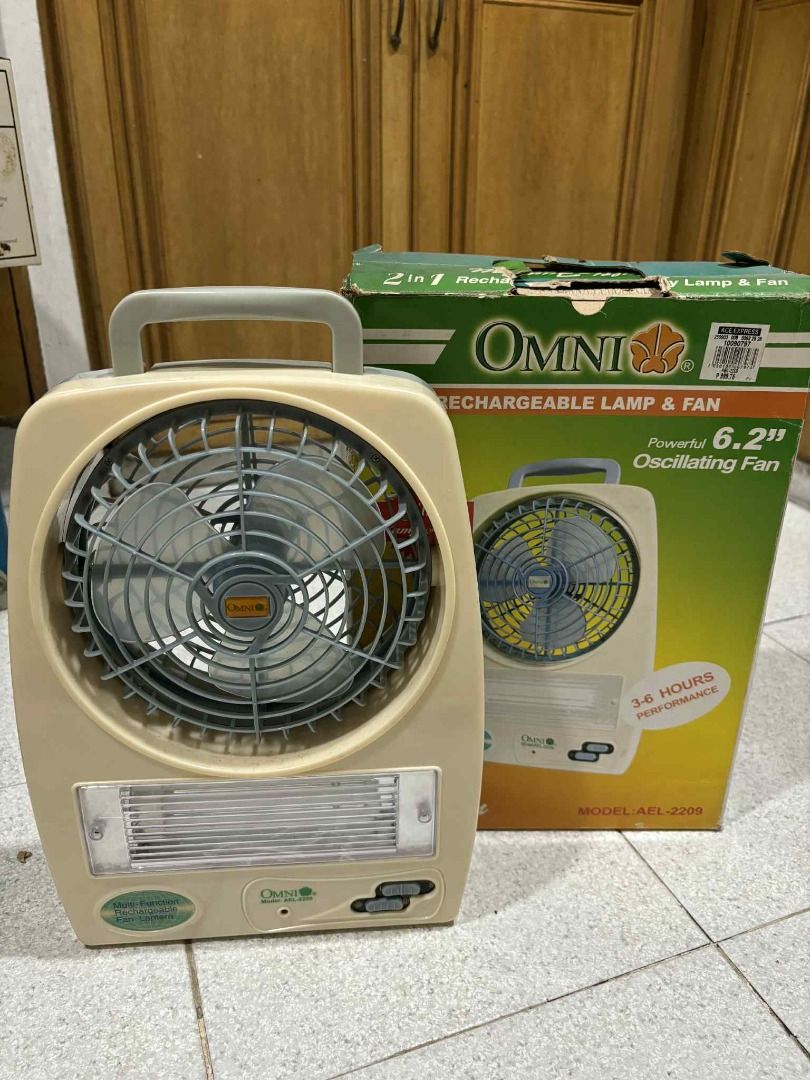 Omni 6.2" Rechargeable Lamp & Fan (Category: Fans) located in Manila. Submitted by jjalbert (Listing ID 1417612656, Image 1). Description: Omni rechargeable lamp and fan is a 2-in-1 device. It features a 6.2" oscillating fan and a lamp. The device has a handle for easy carrying. It is model AFL-2209 and is designed to provide up to 3-6 hours of use. The fan has a beige casing and a protective grill..