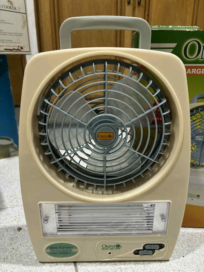 Omni 6.2" Rechargeable Lamp & Fan (Category: Fans) located in Manila. Submitted by jjalbert (Listing ID 1417612656, Image 2). Description: Omni rechargeable lamp and fan is a 2-in-1 device. It features a 6.2" oscillating fan and a lamp. The device has a handle for easy carrying. It is model AFL-2209 and is designed to provide up to 3-6 hours of use. The fan has a beige casing and a protective grill..