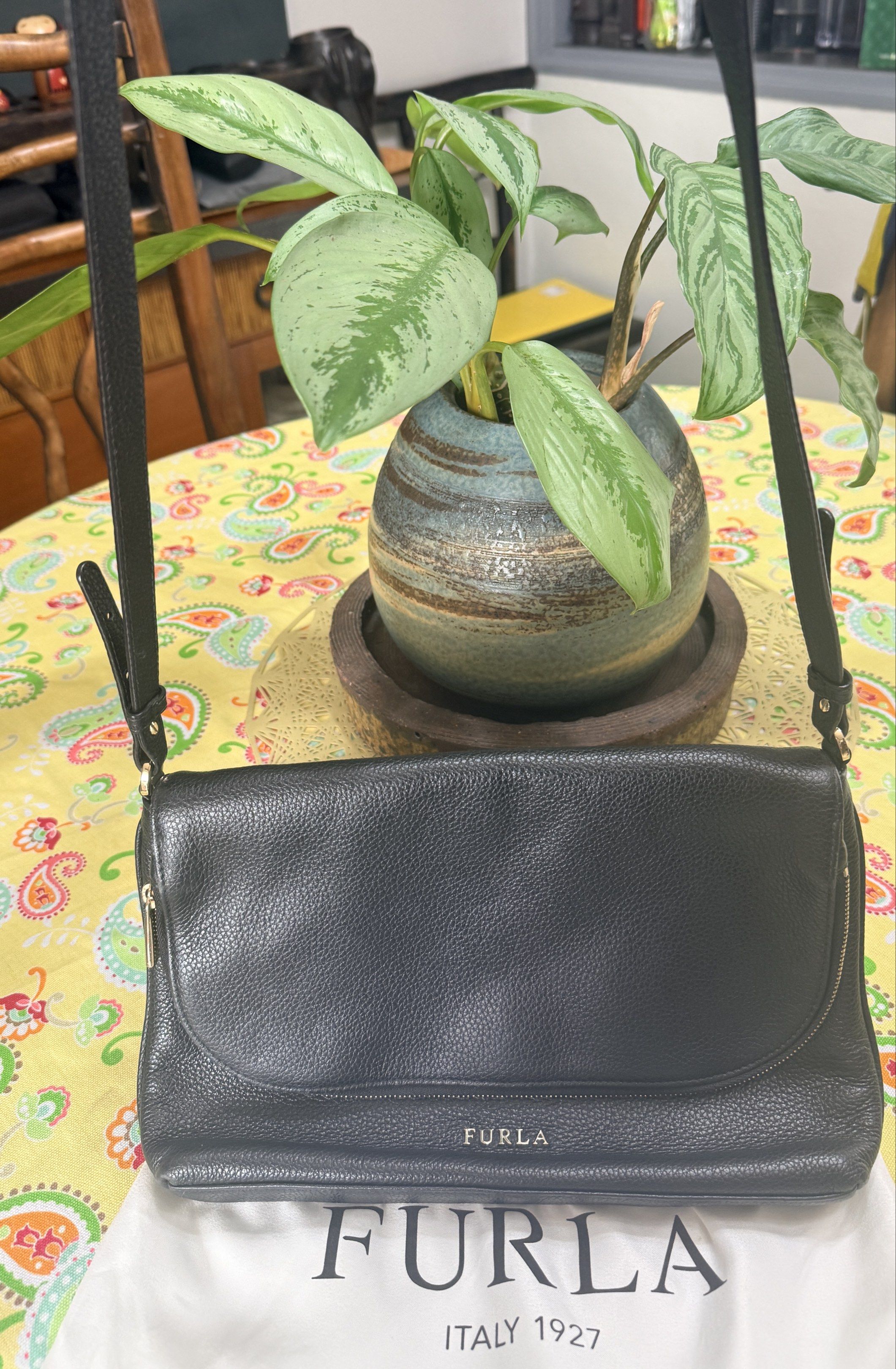 Original Furla Black Leather Shoulder Bag (Category: Luxury Bags & Wallets) located in Quezon City. Submitted by coco88. (Listing ID 1417665495, Image 3). Description: - Black Furla shoulder bag - Flap closure with magnetic snap - Adjustable shoulder strap - Main compartment and small interior pocket - Includes Furla dust bag - Textured leather exterior - Gold-tone Furla logo.