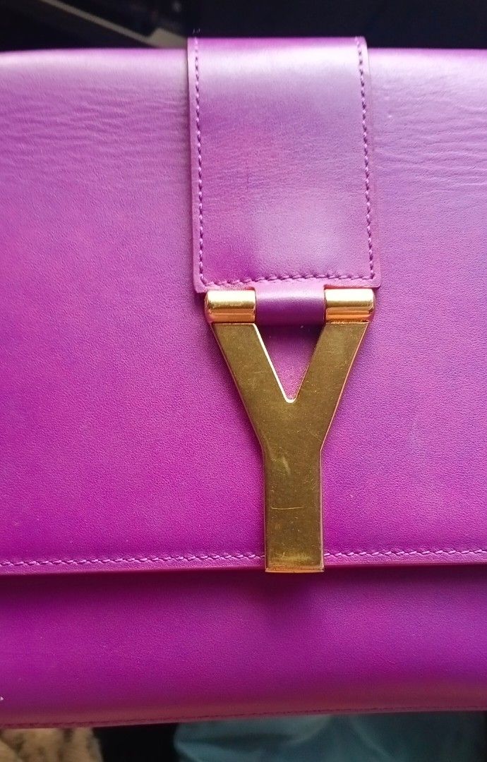 Saint Laurent YSL Clutch Bag (Category: Luxury Bags & Wallets) located in Legazpi City. Submitted by georgepineda791 (Listing ID 1417626523, Image 2). Description: - Preloved Saint Laurent clutch bag -Preloved condition - Stunning purple color - Elegant gold-tone Y-shaped clasp - Features an interior pocket - Includes Saint Laurent label - Comes with a Saint Laurent card - Luxurious leather material - Interior lining in a lighter purple shade ☝️L
