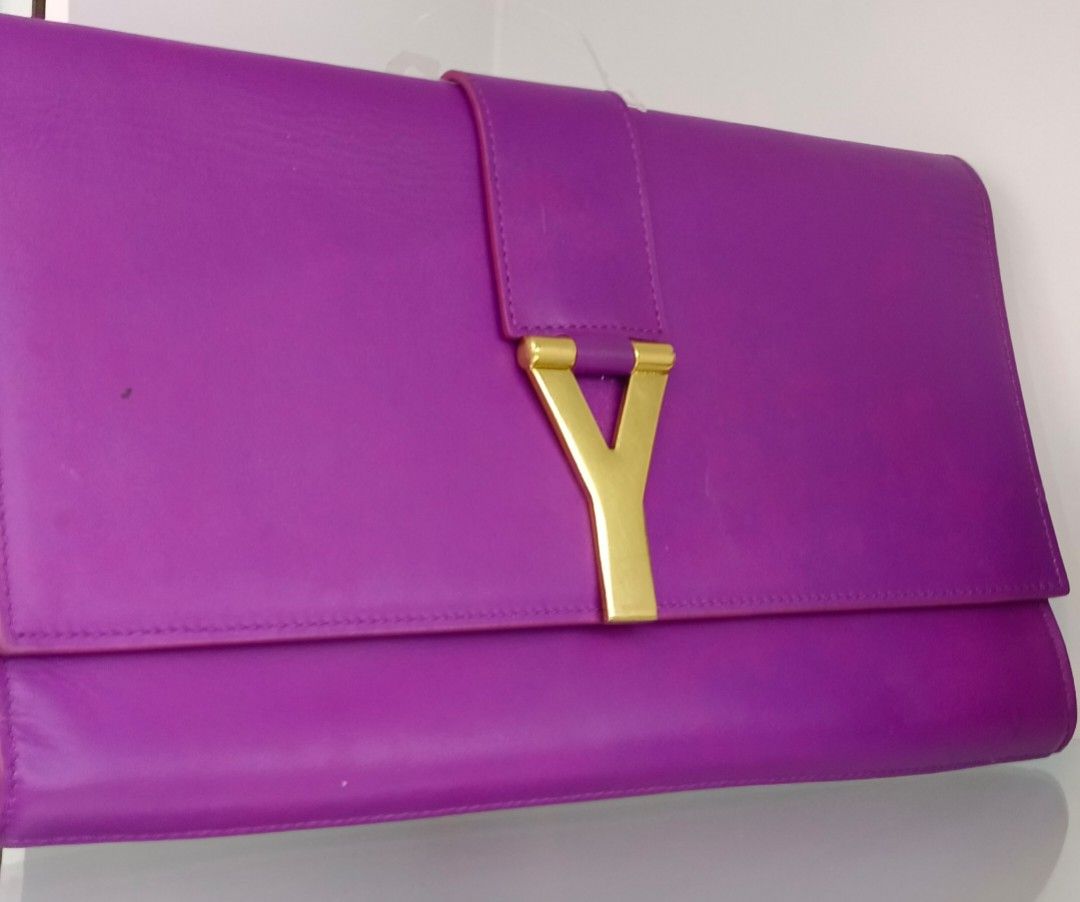 Saint Laurent YSL Clutch Bag (Category: Luxury Bags & Wallets) located in Legazpi City. Submitted by georgepineda791 (Listing ID 1417626523, Image 3). Description: - Preloved Saint Laurent clutch bag -Preloved condition - Stunning purple color - Elegant gold-tone Y-shaped clasp - Features an interior pocket - Includes Saint Laurent label - Comes with a Saint Laurent card - Luxurious leather material - Interior lining in a lighter purple shade ☝️L