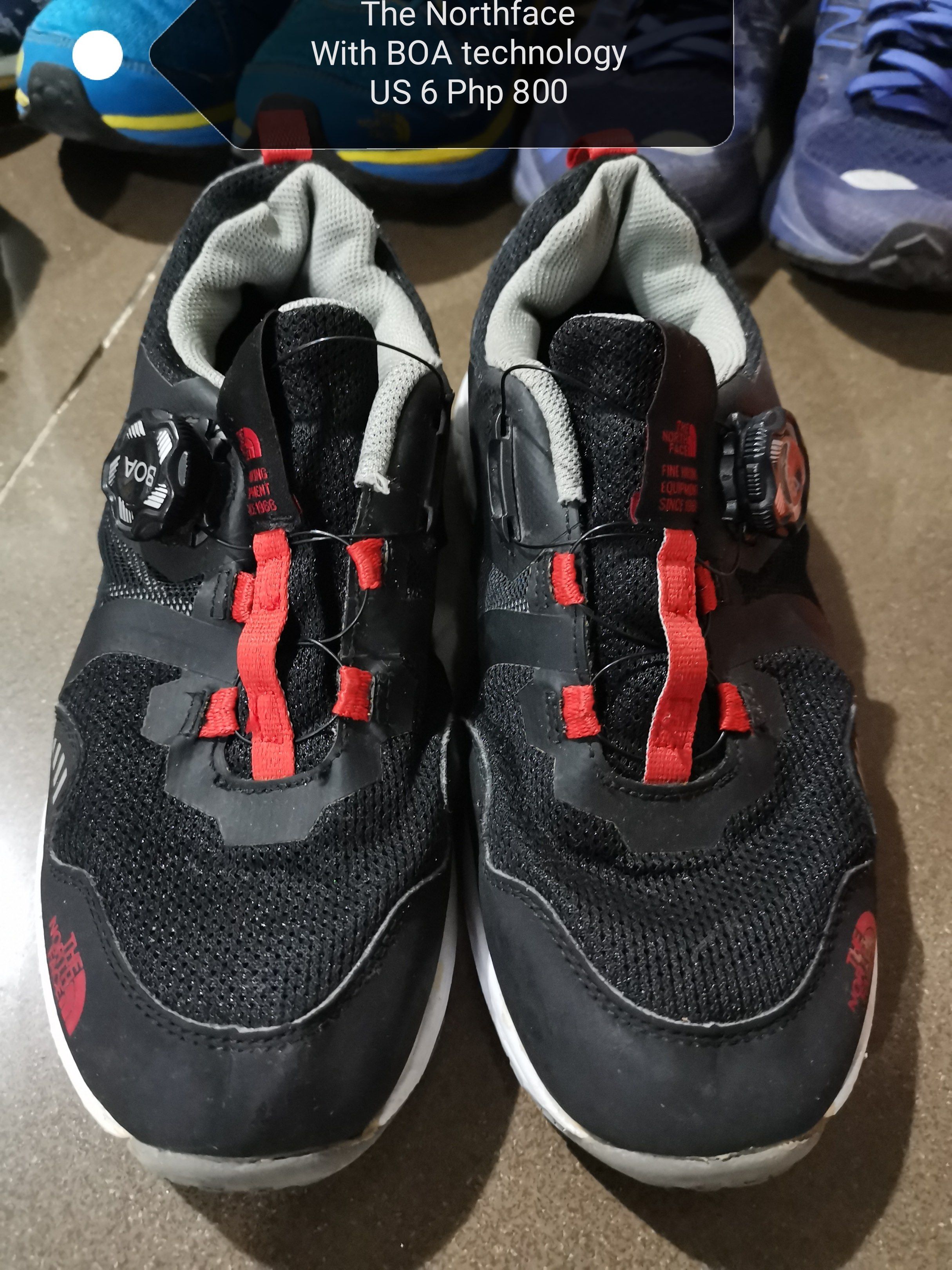 The North Face Shoes with BOA Technology (Category: Sneakers) located in Cavite. Submitted by strawberryandsunset (Listing ID 1417807211, Image 3). Description: - The North Face shoes with BOA technology. - Color: Black with red accents and white sole. - Condition: Shows some wear on the sole. - Features: Breathable mesh upper. - Design: Athletic footwear. - Branding: The North Face logo visible on side and sole..