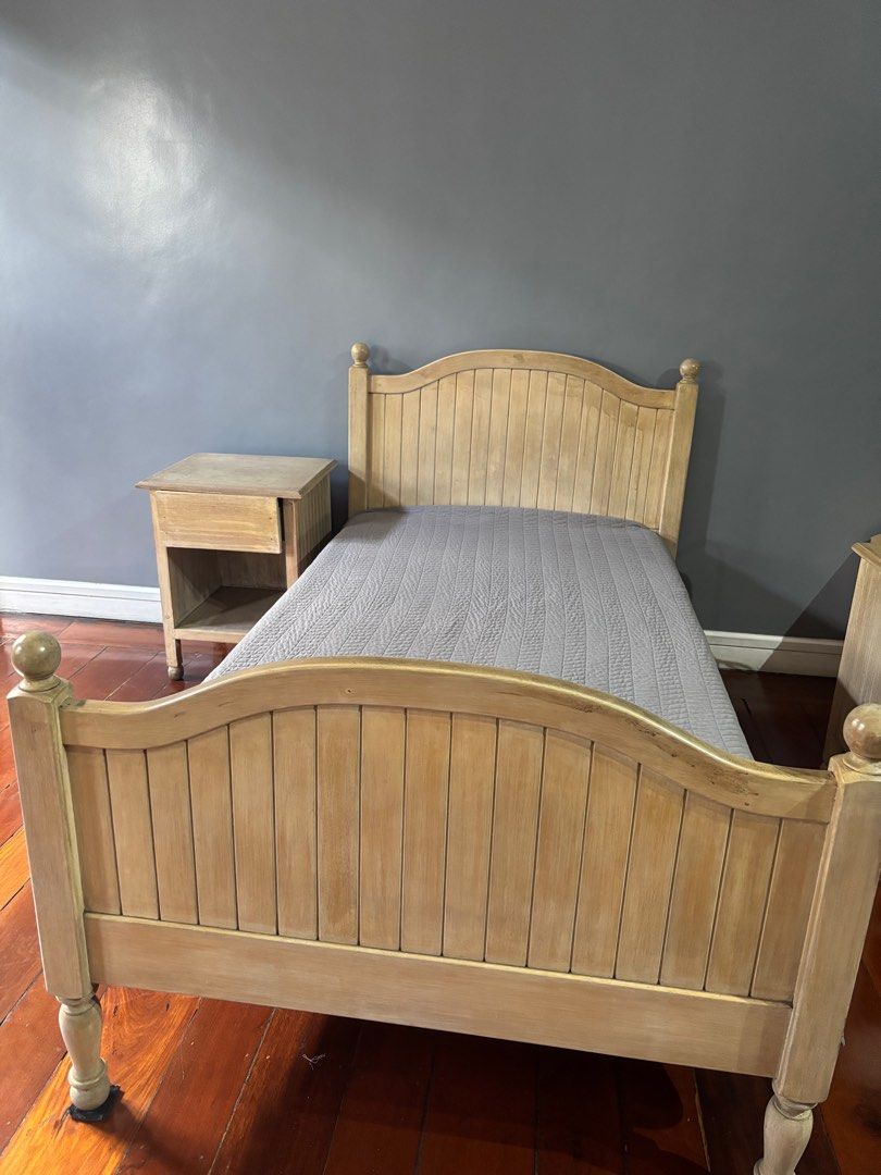 Wooden country style bed frame (Category: Bed Frames & Mattresses) located in Quezon City. Submitted by leacyril (Listing ID 1417615703, Image 1). Description: Solid wood with a light, slightly distressed finish . Vertical beadboard panels on the headboard and footboard with Rounded finials . Bed made by Facolare. Side dresser free .