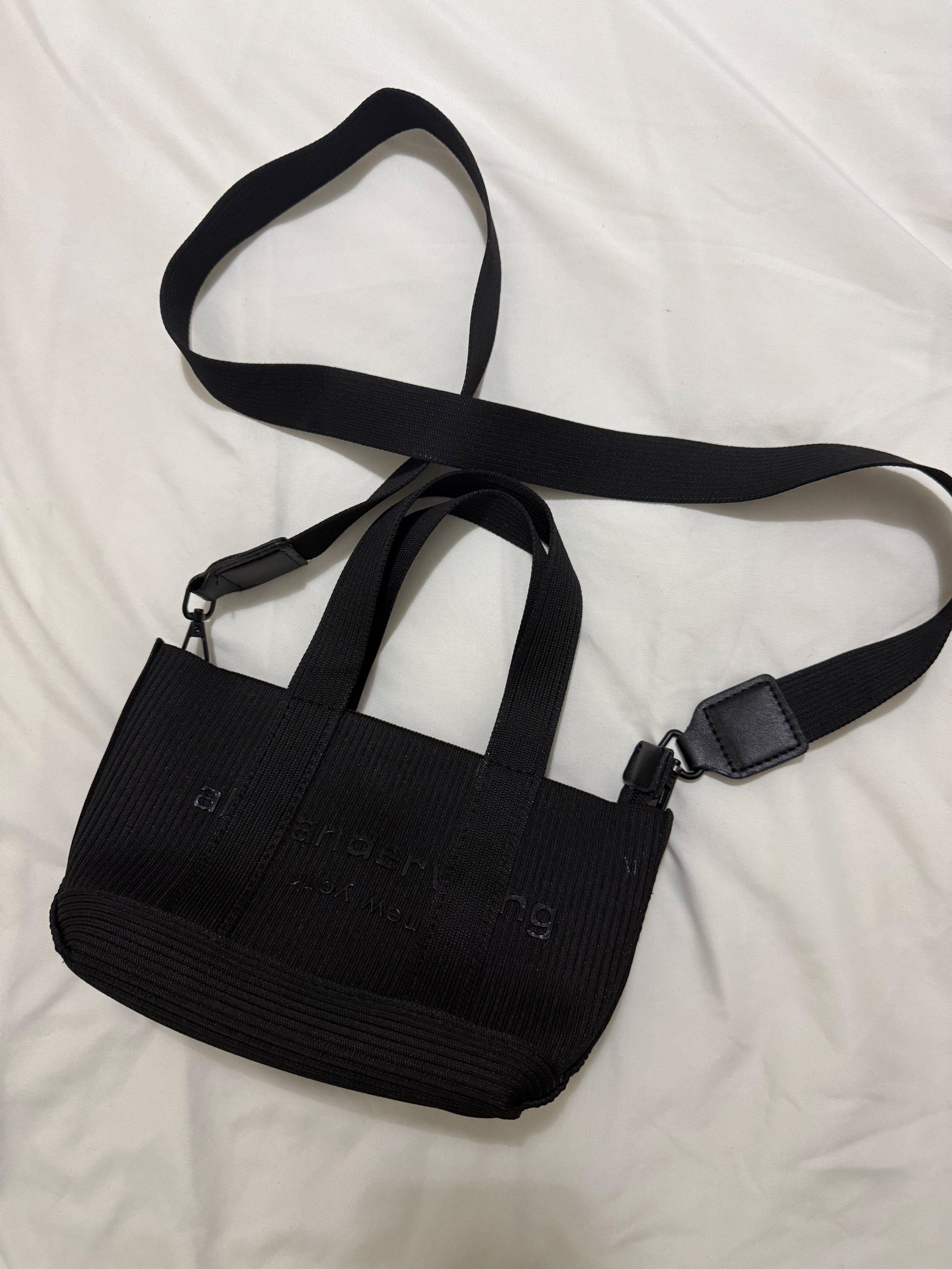 Alexander Wang Mini Tote Bag (Category: Luxury Bags & Wallets) located in Iloilo. Submitted by tanyafrnndz (Listing ID 1417984037, Image 2). Description: - Alexander Wang mini tote bag - Color: Black - Ribbed texture - Detachable shoulder strap - Top handle and crossbody strap - Interior zipper closure - Brand label inside - Includes serial number tag RFS: Decluttering Negotiable ✨ Shipping fee c/o buyer .