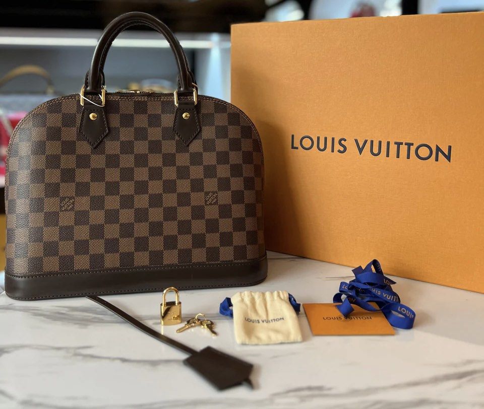 Alma Damier Ebene (Category: Luxury Bags & Wallets) located in Quezon City. Submitted by luxurybrokerph (Listing ID 1417882485, Image 3). Description: comes complete with receipt box paperbag lock and keys dustbag strap.