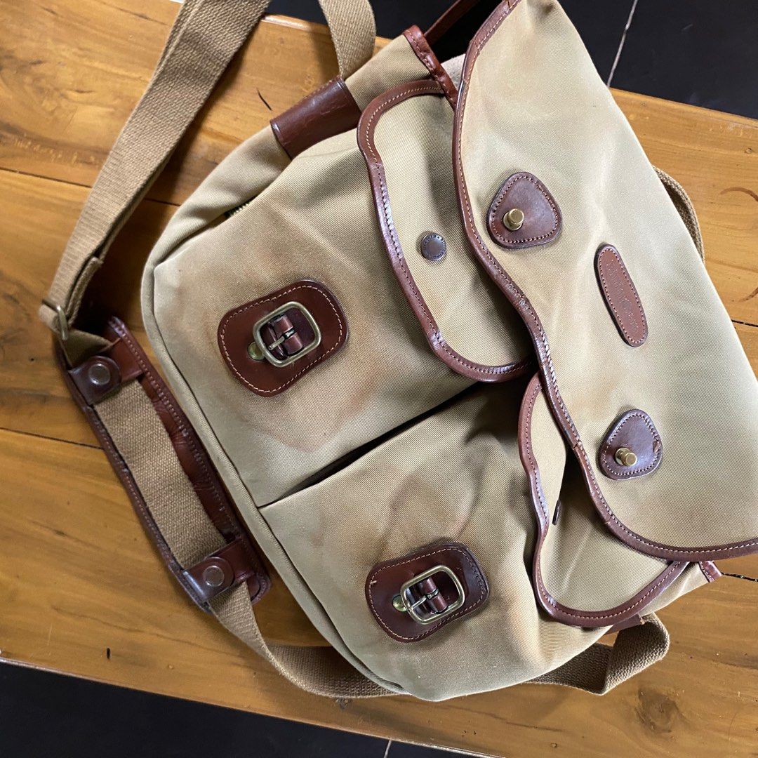 Billingham Hadley Pro-K71 Messenger Bag (Category: Sling Bags) located in Sagbayan (Borja). Submitted by lunapawpaw46843 (Listing ID 1417890831, Image 2). Description: - Billingham Hadley Pro-K71 Messenger Bag - Tan canvas exterior with brown leather accents - Multiple compartments for organization - Secure zipper closure - Adjustable shoulder strap - Features the Billingham England logo - High-quality YKK zipper.