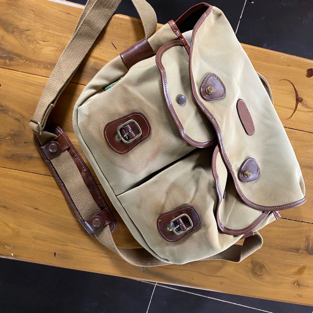 Billingham Hadley Pro-K71 Messenger Bag (Category: Sling Bags) located in Sagbayan (Borja). Submitted by lunapawpaw46843 (Listing ID 1417890831, Image 3). Description: - Billingham Hadley Pro-K71 Messenger Bag - Tan canvas exterior with brown leather accents - Multiple compartments for organization - Secure zipper closure - Adjustable shoulder strap - Features the Billingham England logo - High-quality YKK zipper.