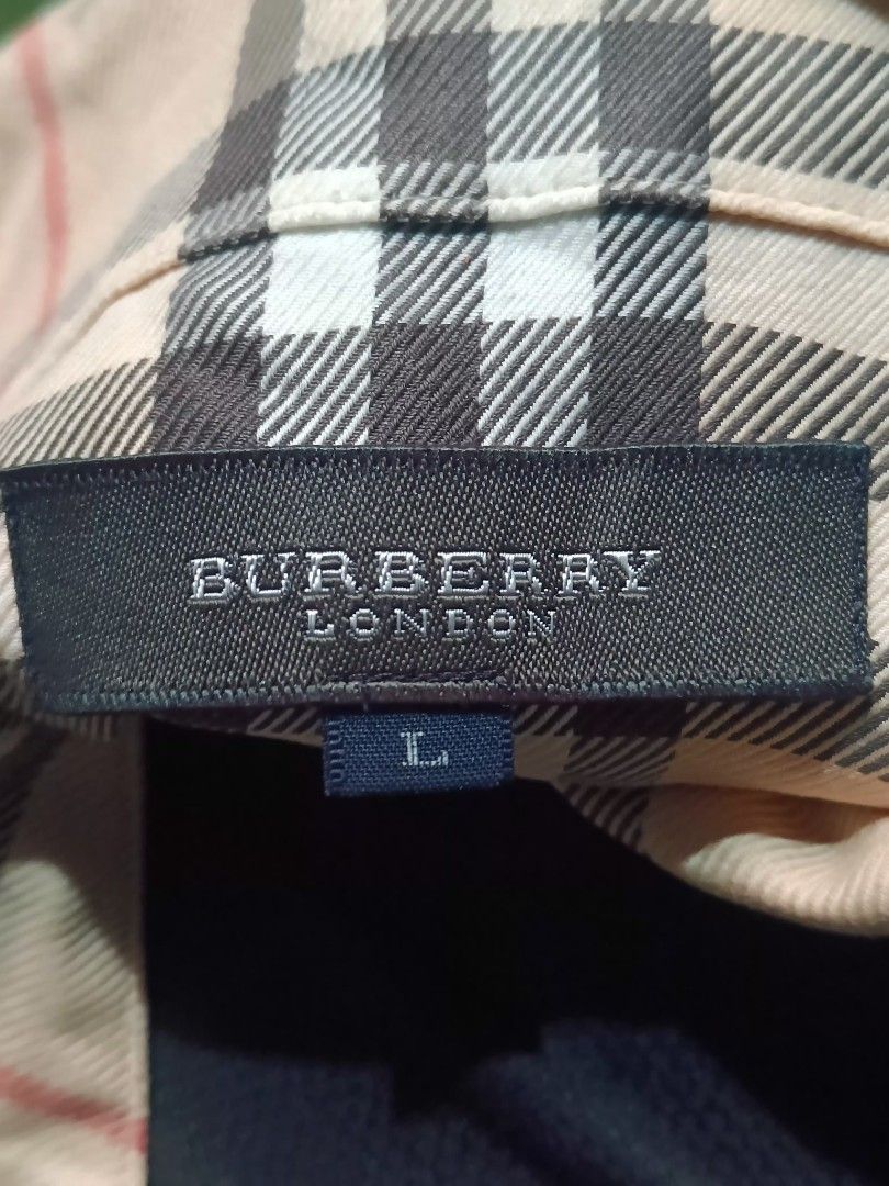 Burberry London Checkered Shirt - Large (Category: Tshirts & Polo Shirts ) located in Reina Mercedes. Submitted by SIRCHIVES (Listing ID 1417829500, Image 2). Description: - Authentic Burberry London shirt - Classic Burberry check pattern (beige, black, red) - Size: Large - Button-down style - Collared neckline - Chest pocket with button - Features Burberry London logo.