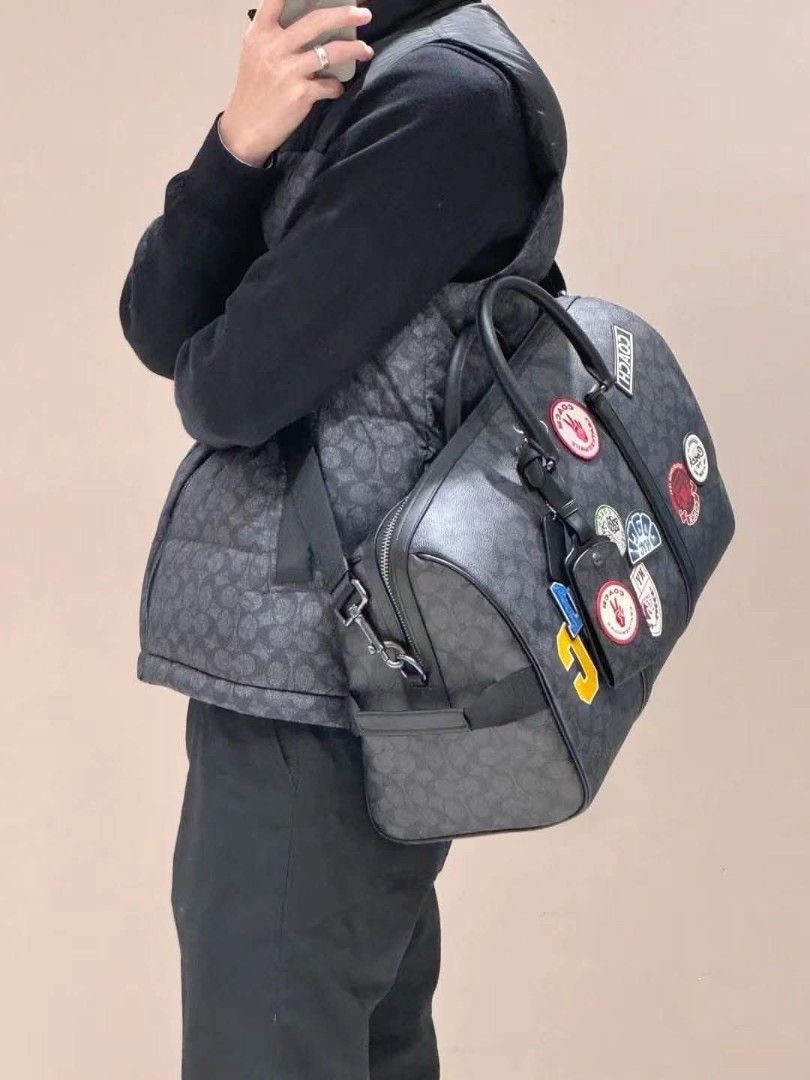 Coach Signature Patchwork Duffle Bag (Category: Luxury Bags & Wallets) located in Manila. Submitted by santosrich_419 (Listing ID 1417897361, Image 1). Description: - Coach duffle bag - Signature pattern - Top handle and detachable shoulder strap - Includes Coach hangtag - Zipper closure - Spacious design - Dark grey with black accents.
