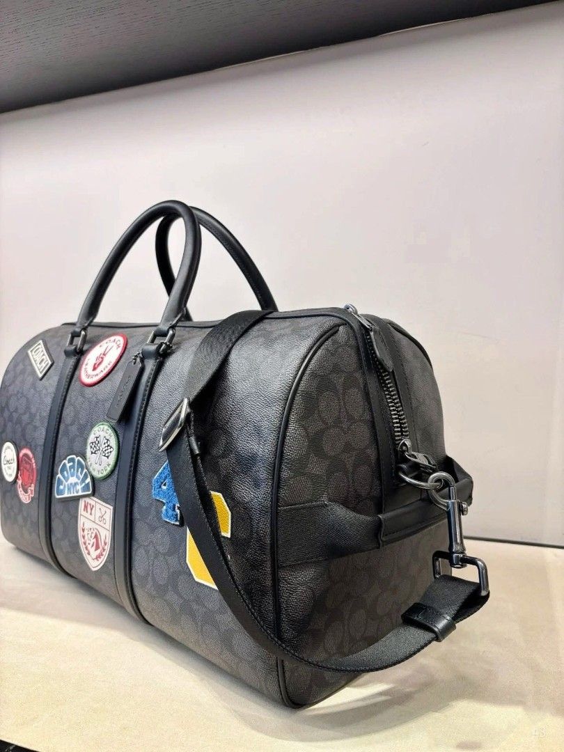 Coach Signature Patchwork Duffle Bag (Category: Luxury Bags & Wallets) located in Manila. Submitted by santosrich_419 (Listing ID 1417897361, Image 3). Description: - Coach duffle bag - Signature pattern - Top handle and detachable shoulder strap - Includes Coach hangtag - Zipper closure - Spacious design - Dark grey with black accents.
