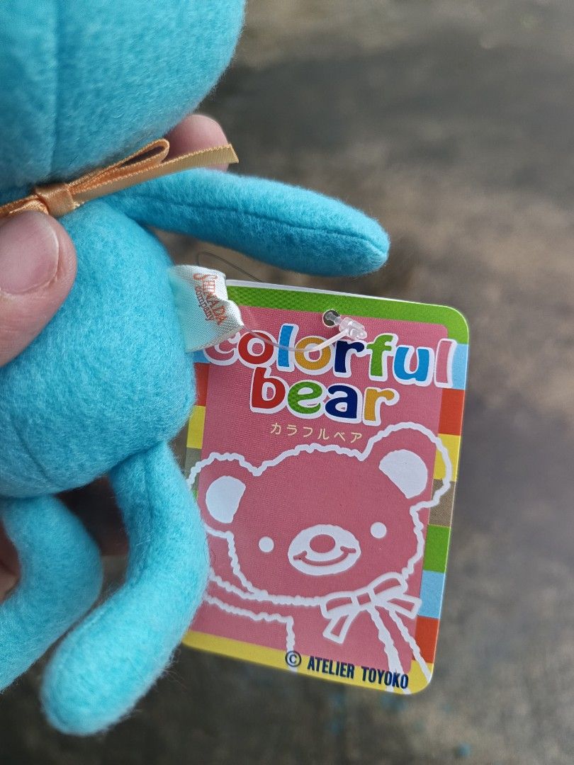 Colorful Bear Plush Toy shinada (Category: Plushies & Soft Toys) located in Daet. Submitted by heracaramel (Listing ID 1417931733, Image 3). Description: - Adorable bear plush toy - Features a teal body with brown accents - Includes a small yellow ribbon - Comes with original tag - Perfect for collectors or gifts.