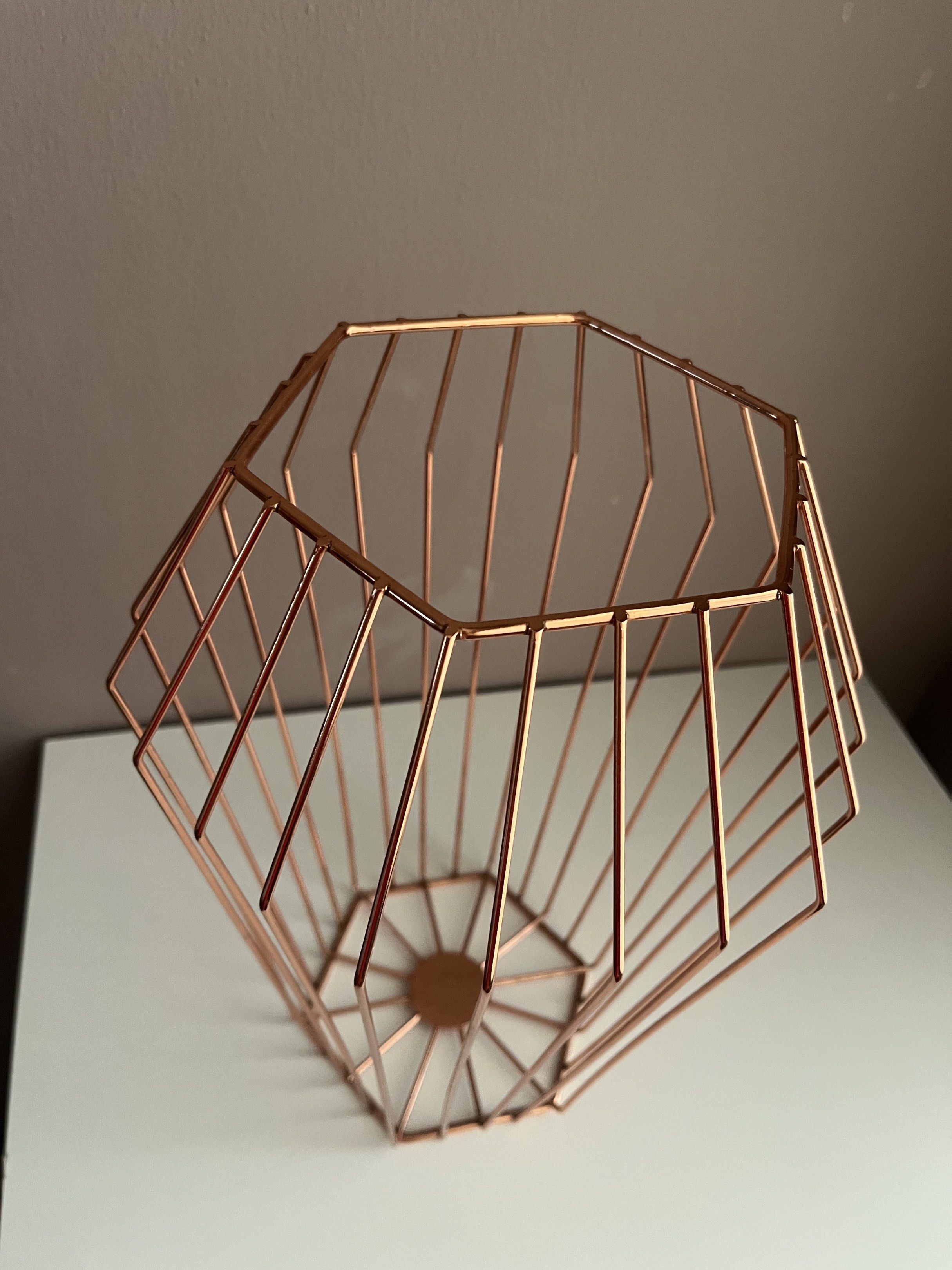 Copper Wire Geometric Basket (Category: Storage Boxes & Baskets) located in Quezon City. Submitted by littleparties (Listing ID 1417954238, Image 3). Description: - Geometric copper wire basket - Unique shape with open top - Sturdy base - Ideal for fruits, small items, or decor - Modern and elegant design - Lightweight and easy to move.