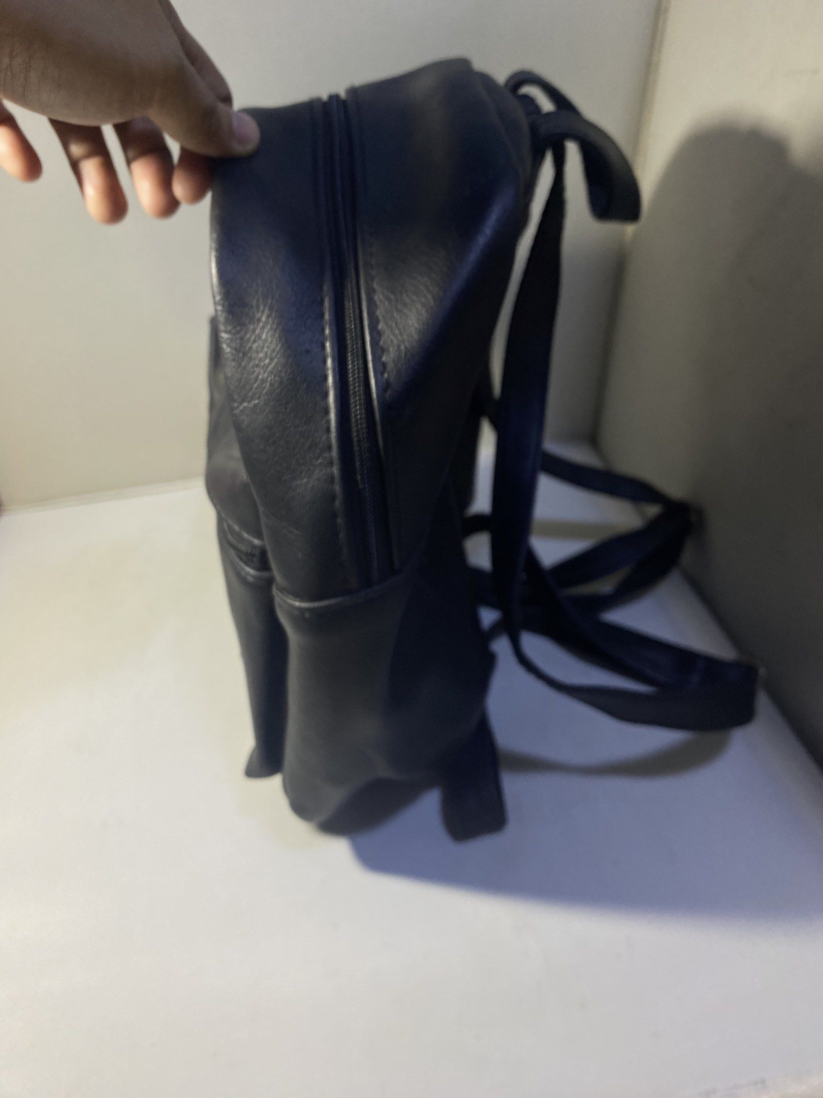 Dickies Black Mini Backpack (Category: Backpacks) located in Pasacao. Submitted by wengpullar37205 (Listing ID 1417943088, Image 2). Description: Black mini backpack features a front pocket with a zipper and a Dickies logo patch. It has adjustable straps and a top handle. The main compartment has a zipper closure. It's a compact size, suitable for carrying essentials..