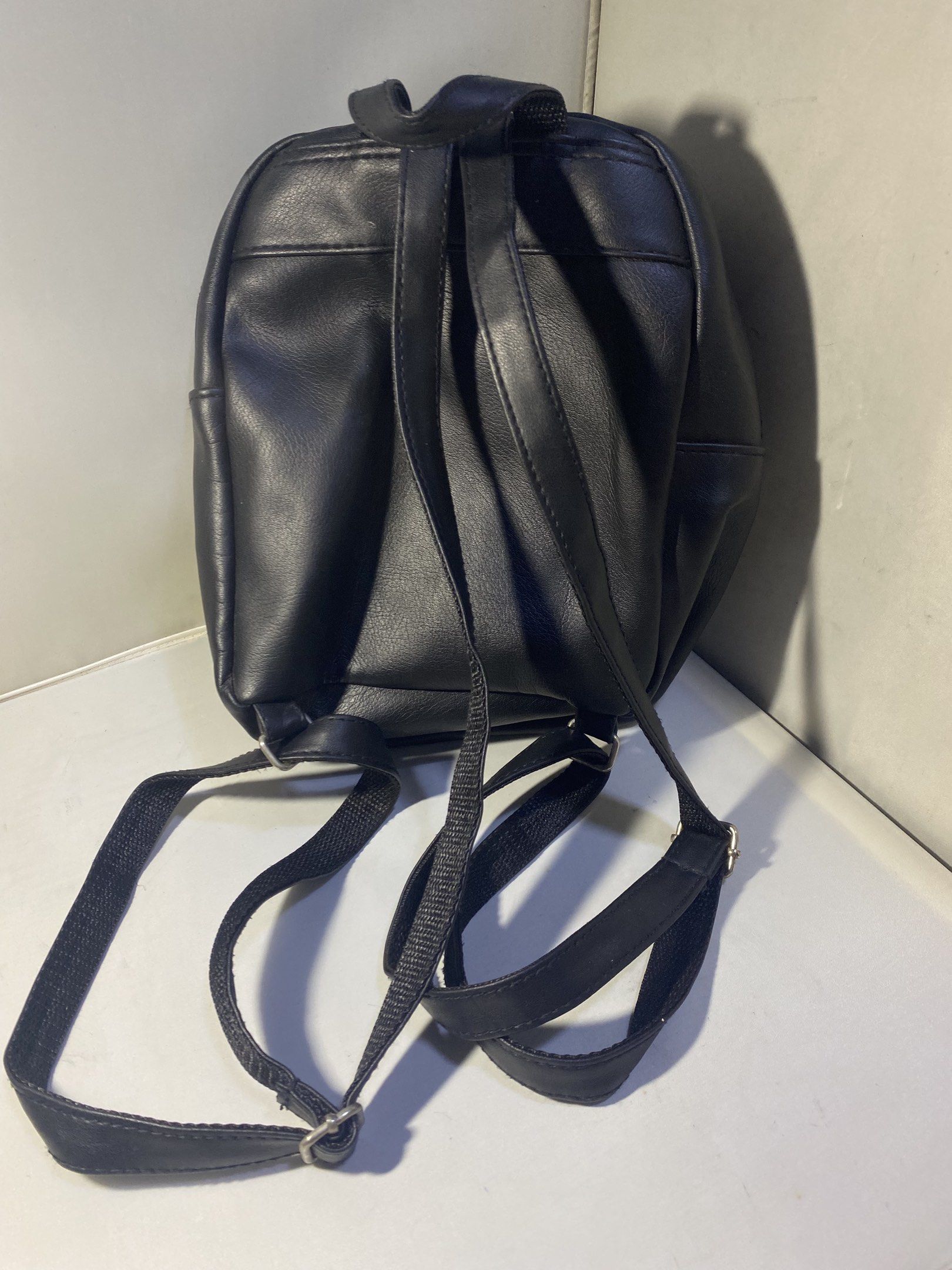 Dickies Black Mini Backpack (Category: Backpacks) located in Pasacao. Submitted by wengpullar37205 (Listing ID 1417943088, Image 3). Description: Black mini backpack features a front pocket with a zipper and a Dickies logo patch. It has adjustable straps and a top handle. The main compartment has a zipper closure. It's a compact size, suitable for carrying essentials..