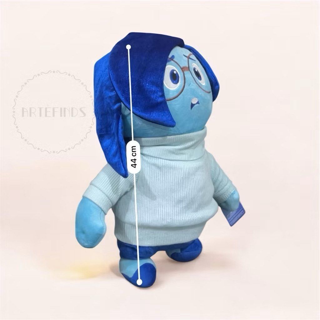 Disney Pixar Inside Out Sadness Plush Toy (Category: Plushies & Soft Toys) located in Pasig City. Submitted by pinkfluff17 (Listing ID 1417994760, Image 2). Description: Plush toy of Sadness from the Disney Pixar movie Inside Out. It has a blue color scheme and is wearing a light blue sweater. The toy has a tag attached. It measures approximately 44 cm in height..