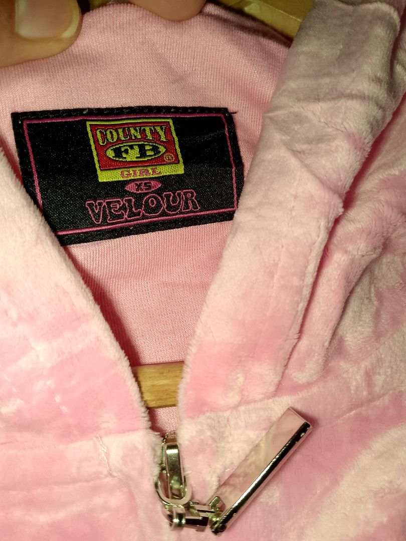 FB county Velour Hoodie XS (Category: Coats, Jackets and Outerwear) located in General Trias. Submitted by elmerafelix-42143 (Listing ID 1417910044, Image 3). Description: - County FB pink velour hoodie - Size: XS - Dimensions W 18 L 21 - Features a zip-up front and hood - Includes brand logo patch - Made of soft, comfortable velour - Perfect for casual wear.