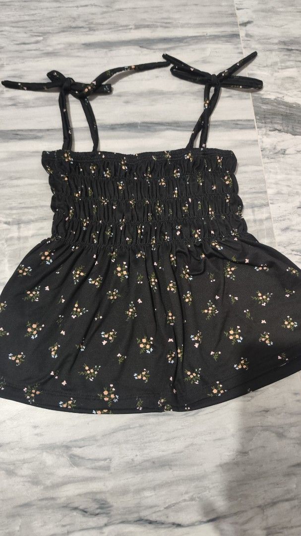 Floral Smocked Top with Tie Straps (Category: Sleeveless) located in Cavite. Submitted by nesstuffandeverything (Listing ID 1417879890, Image 1). Description: - Black floral smocked top with tie straps - Fitted bodice and slightly flared hem - Delicate white and yellow floral pattern - Includes two tube tops: pink and tan - Gray sleeveless top with 'URBANE' print s-m sizes.
