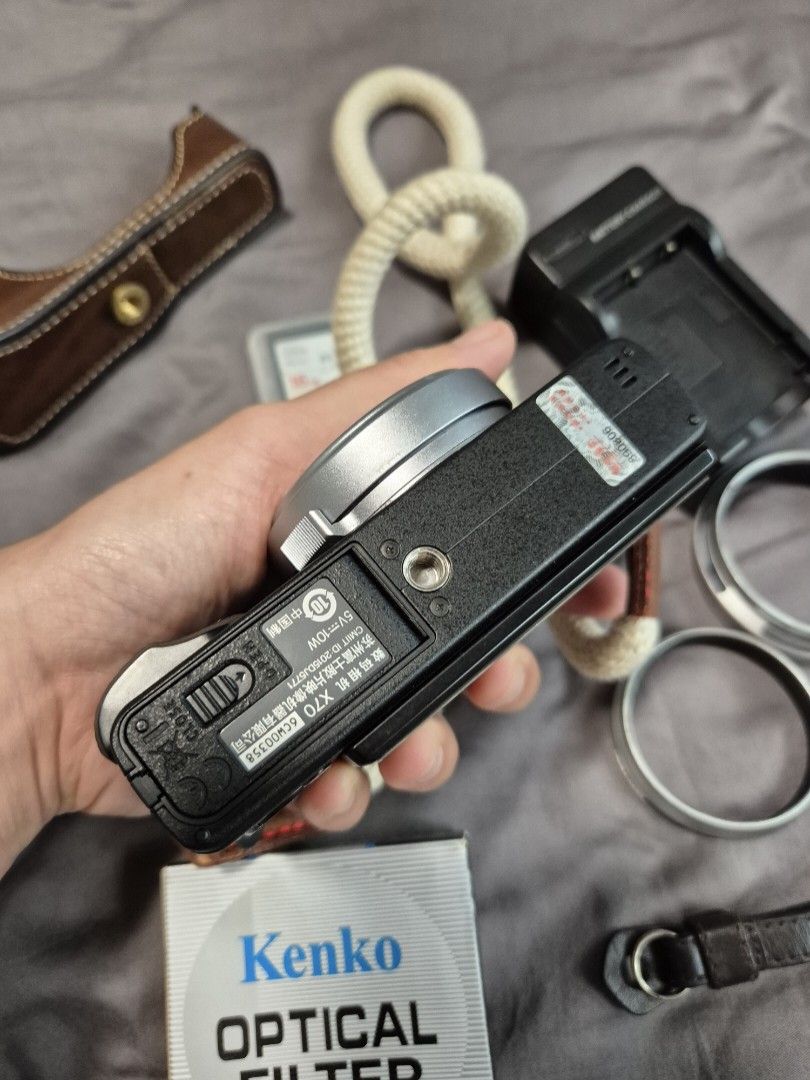 Fujifilm X70 Digital Camera (Category: Cameras) located in Las Pinas. Submitted by katdideles (Listing ID 1417828587, Image 3). Description: - Fujifilm X70 digital camera - Silver body with black grip - Includes: - Camera half case case - Kenko optical filter - Wall Charger - Strap - SD card (2pcs 64gig and 16gig) - 3 batteries - No box RFS: hardly using this anymore Issues / notes: Camera has a scratched screen protector but no issue with the ac