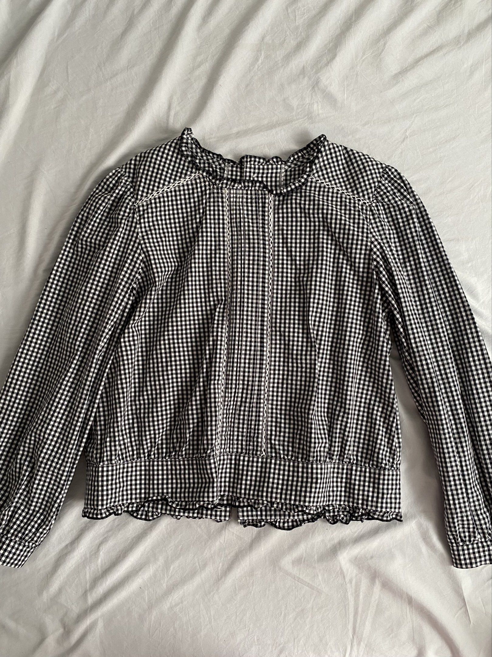 Gingham Ruffle Blouse (Category: Blouses) located in Manila. Submitted by chocoxlb__ (Listing ID 1417850337, Image 1). Description: - Classic black and white gingham pattern - Long sleeves - Ruffled neckline and hem - Fitted silhouette with gathered waist - Button closure at the back - Dress it up or down!.