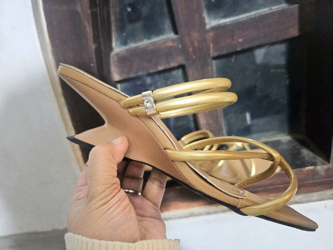 Gold Strappy Heels (Category: Heels) located in Manila. Submitted by honeypatch (Listing ID 1417959155, Image 3). Description: Elegant gold strappy heels with a unique heel design. Features a square toe and multiple straps for a secure fit. The sandals have a light brown footbed. Perfect for special occasions or adding a touch of glamour to any outfit. .