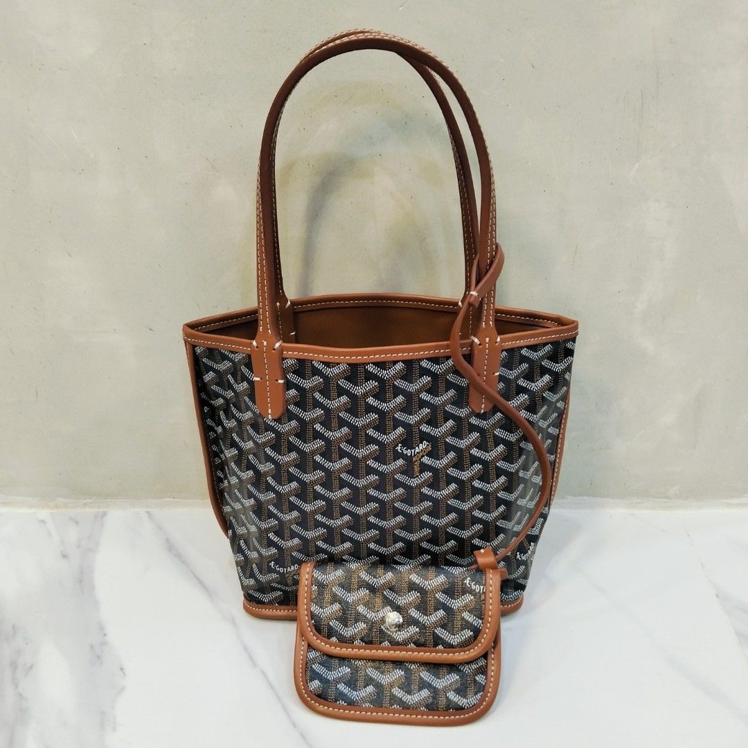 Goyard Mini Tote Bag with Pouch (Category: Luxury Bags & Wallets) located in Dagupan City. Submitted by youngthrift_ (Listing ID 1417847329, Image 1). Description: Goyard mini tote bag with matching pouch. Features the signature Goyardine pattern in black and brown. The bag has brown leather trim and handles with white stitching. The pouch has a snap closure and is stamped with "Goyard Paris Made in France". The interior of the bag is brown leath